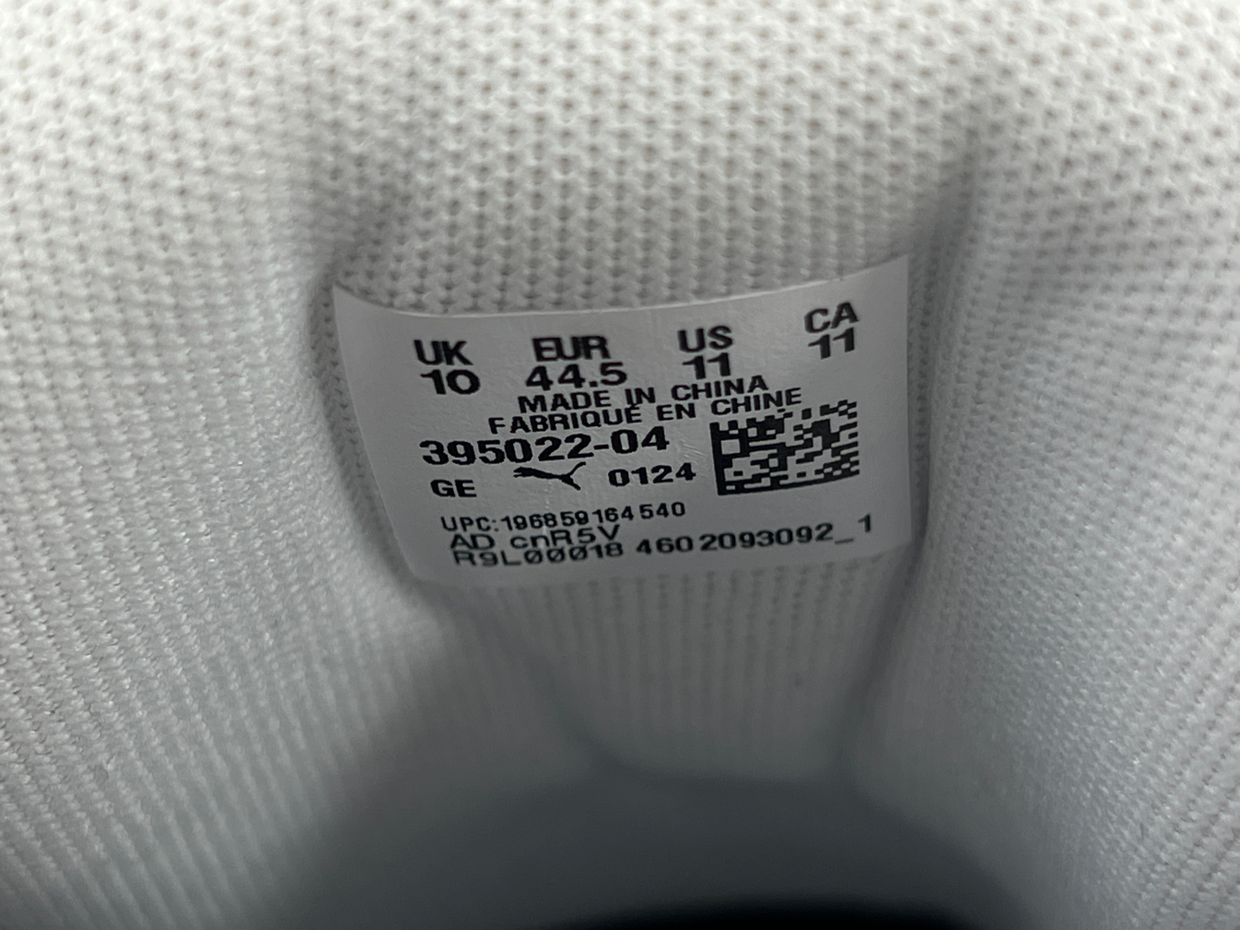 A pair of Puma sneakers in white and navy color scheme