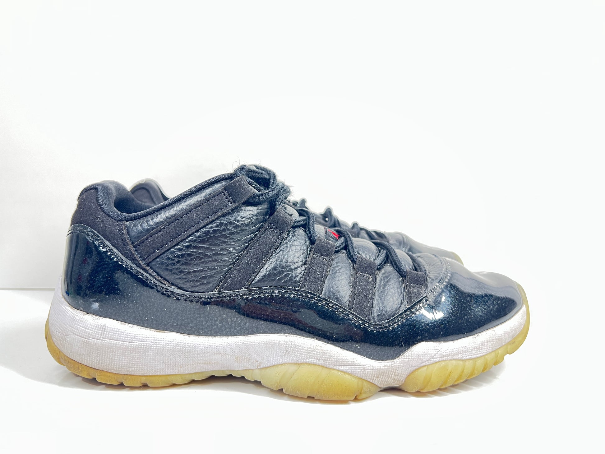 A pair of black Nike Air Jordan Retro 11 Low AV2187-001 sneakers.