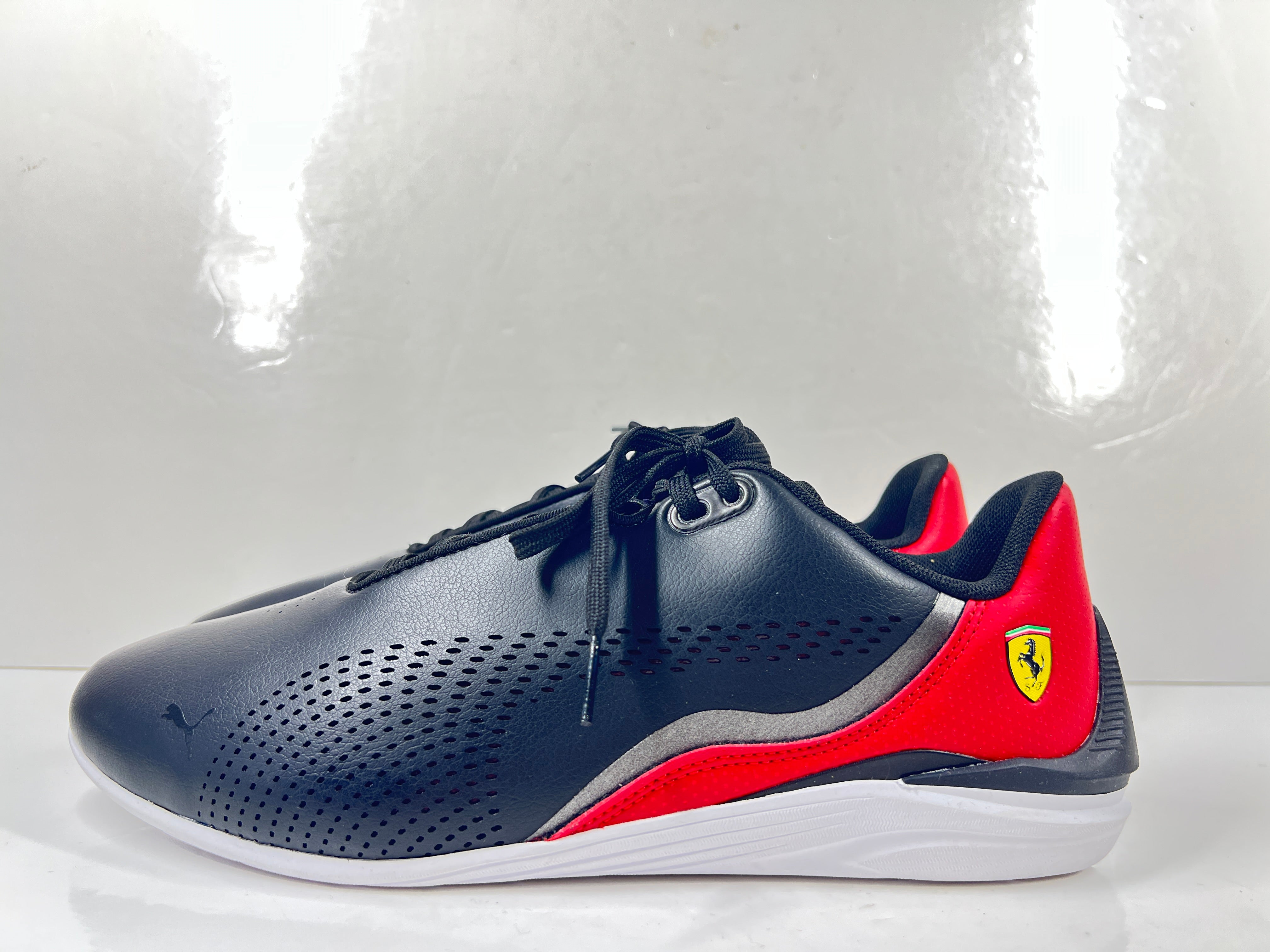 A pair of black and red Puma Scuderia Ferrari Kart Cat III shoes