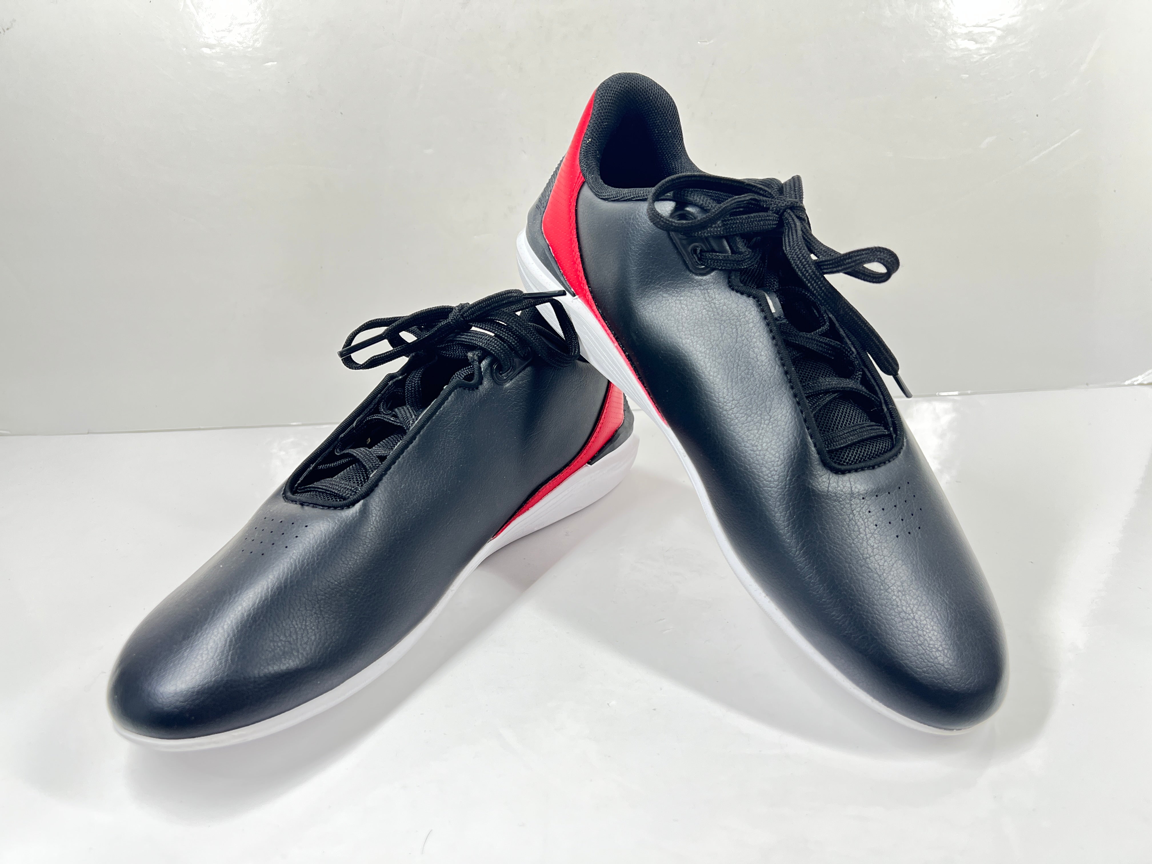 A pair of black and red Puma Scuderia Ferrari Kart Cat III shoes