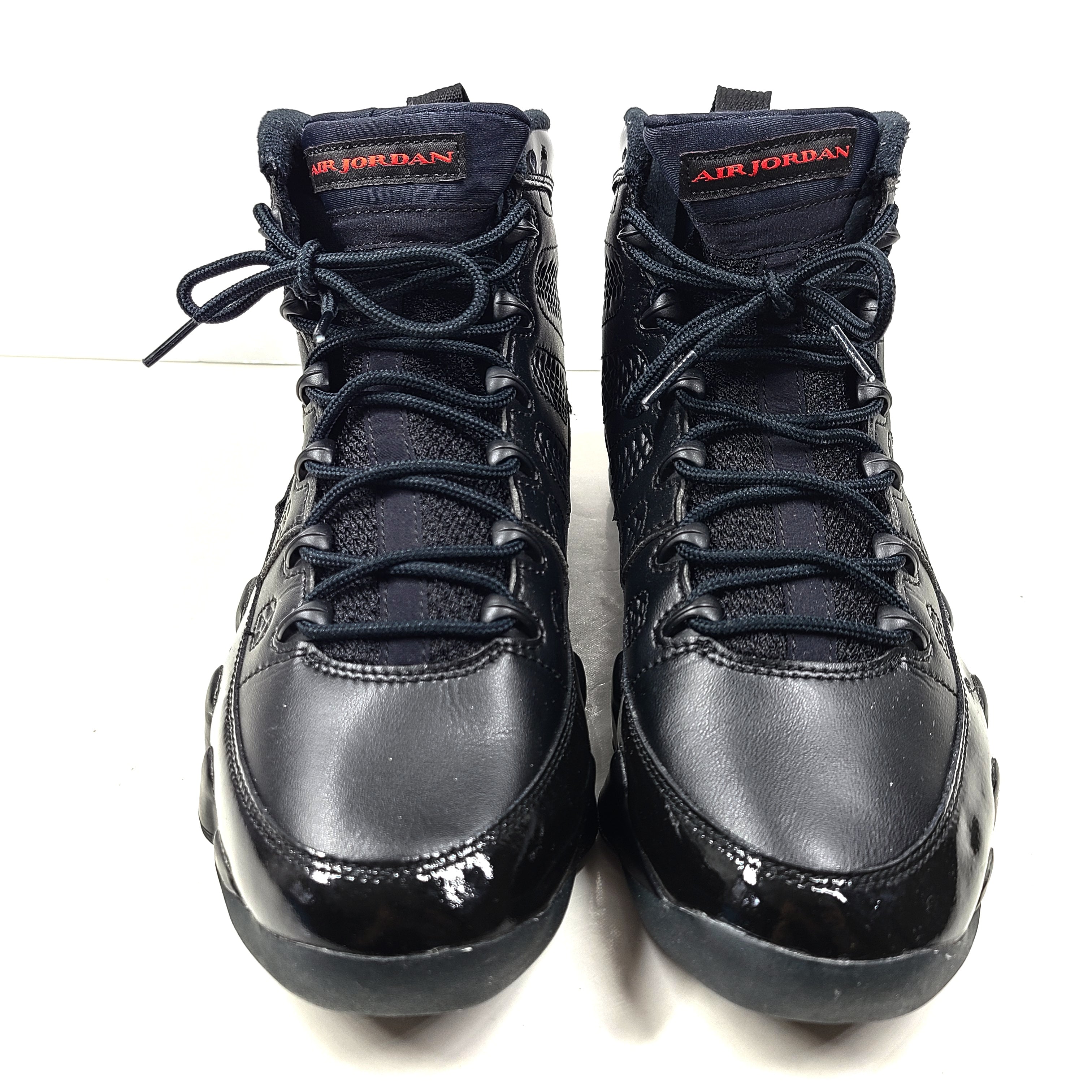 A pair of Nike Air Jordan Retro 9 Black/Red sneakers in size 9.5