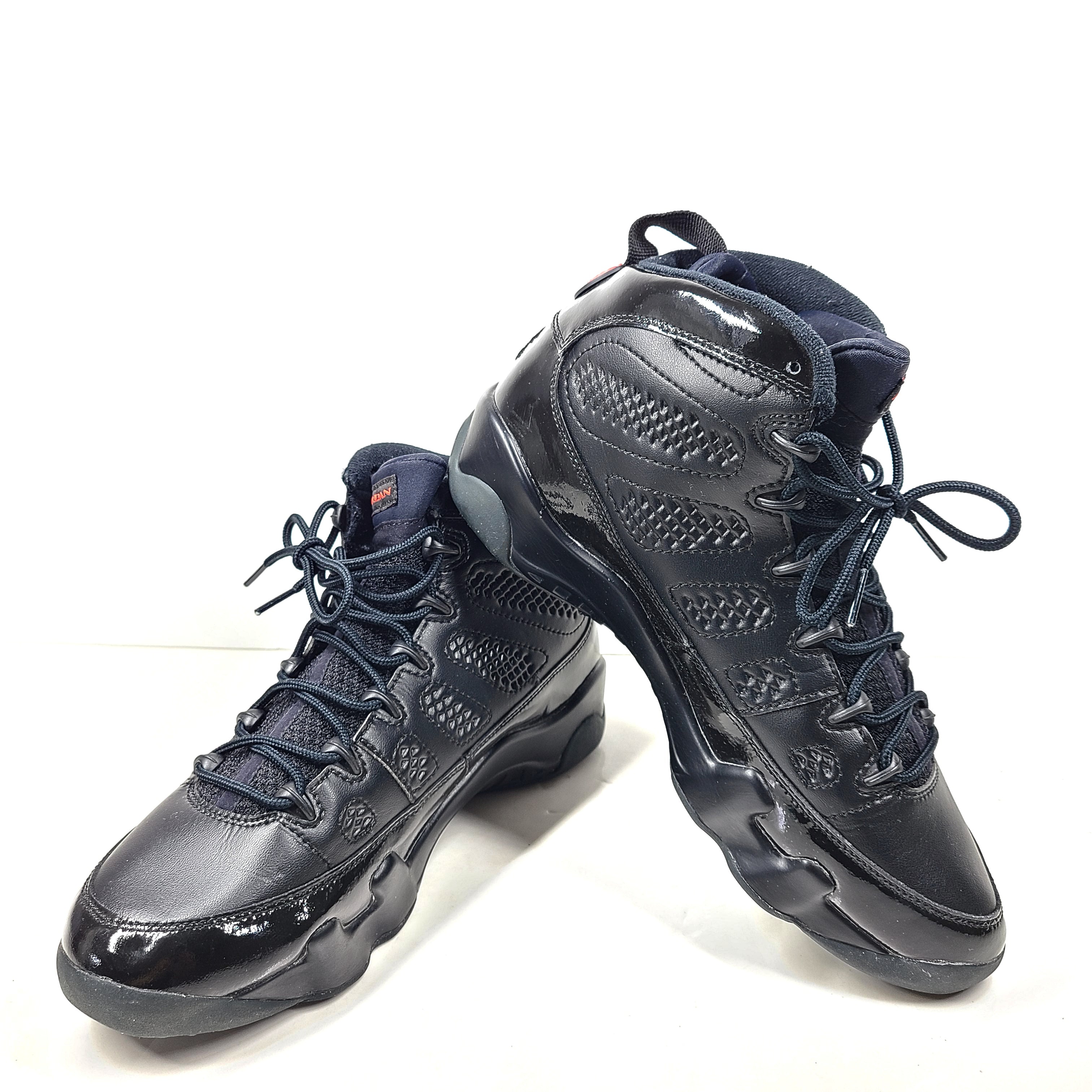 A pair of Nike Air Jordan Retro 9 Black/Red sneakers in size 9.5