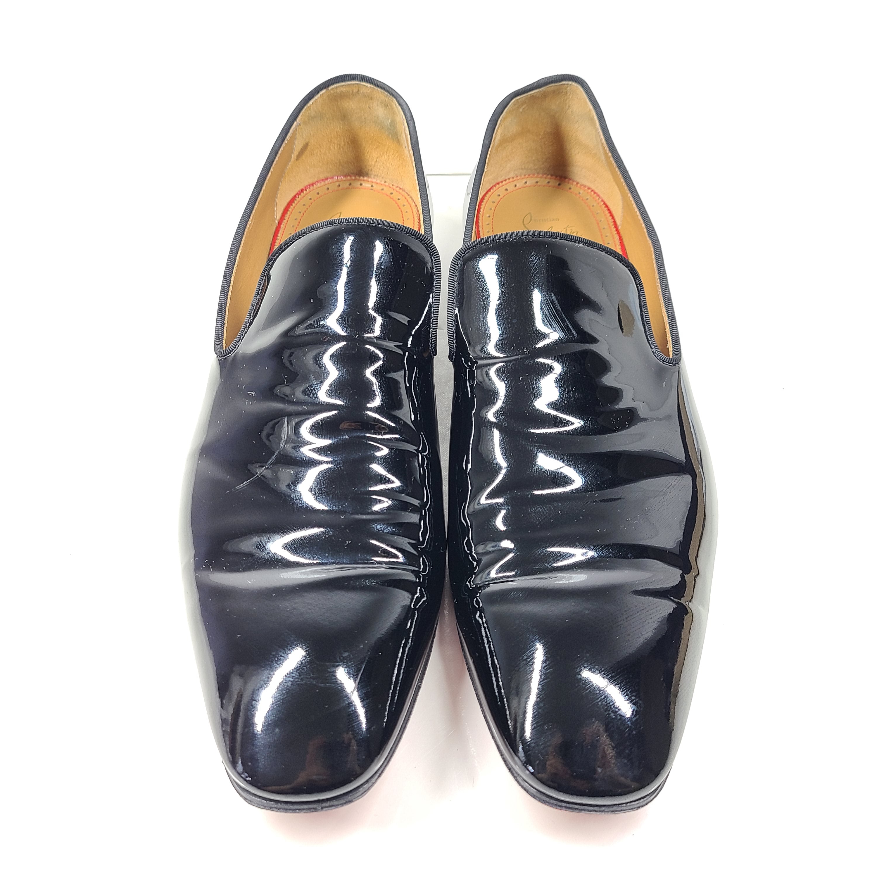 A pair of black patent leather loafers by Christian Louboutin