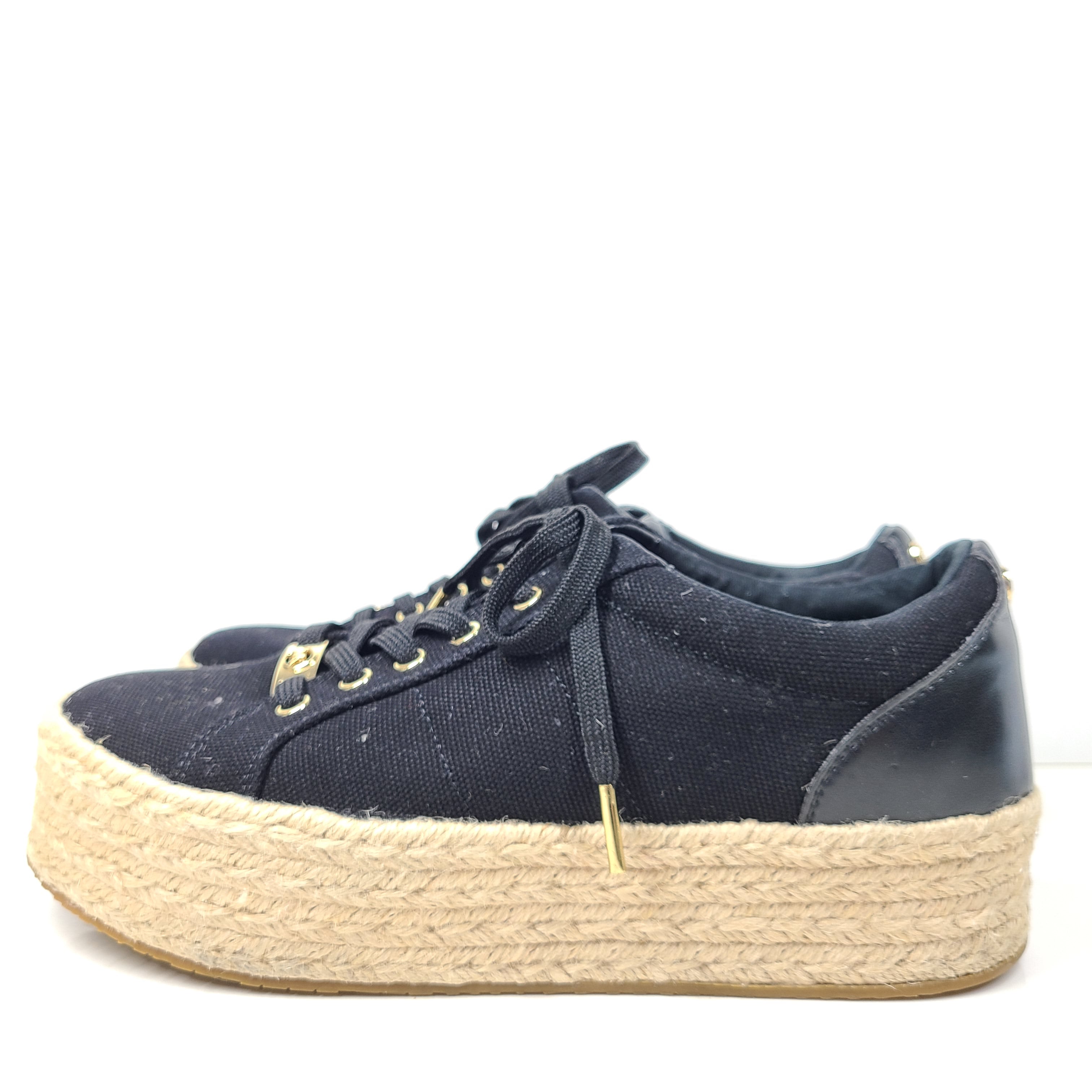 A pair of Michael Kors Women's Platform Sneakers in Black and Gold