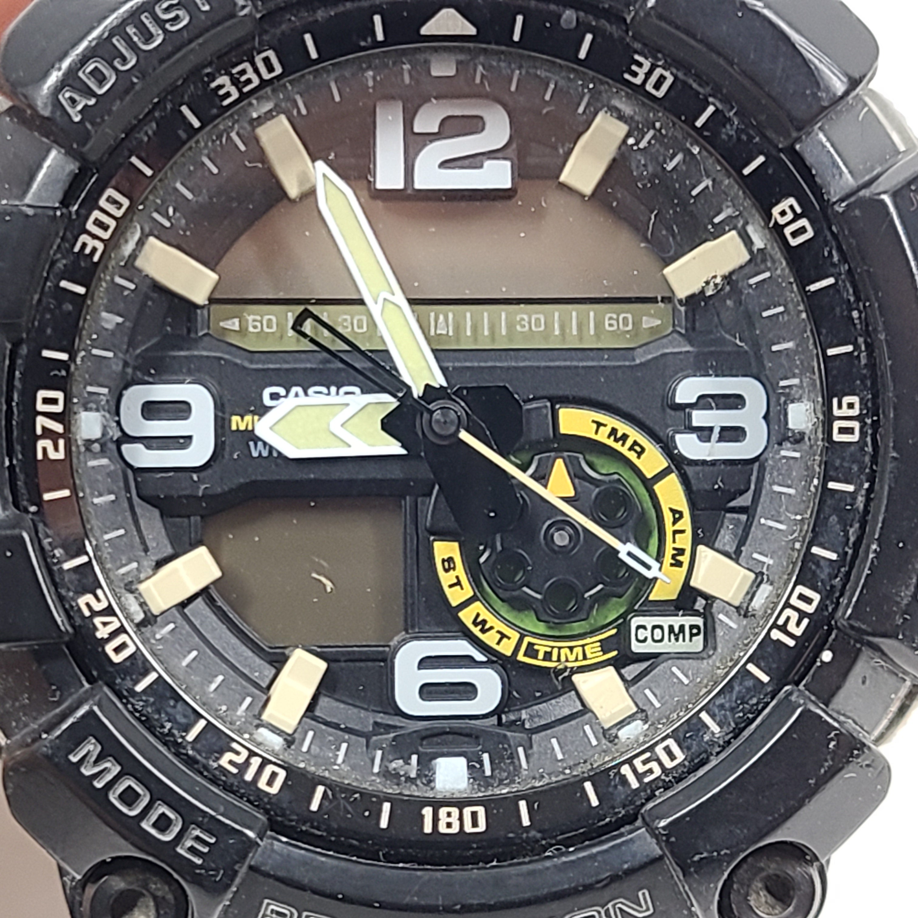 A military green Casio G-Shock watch on a strap.