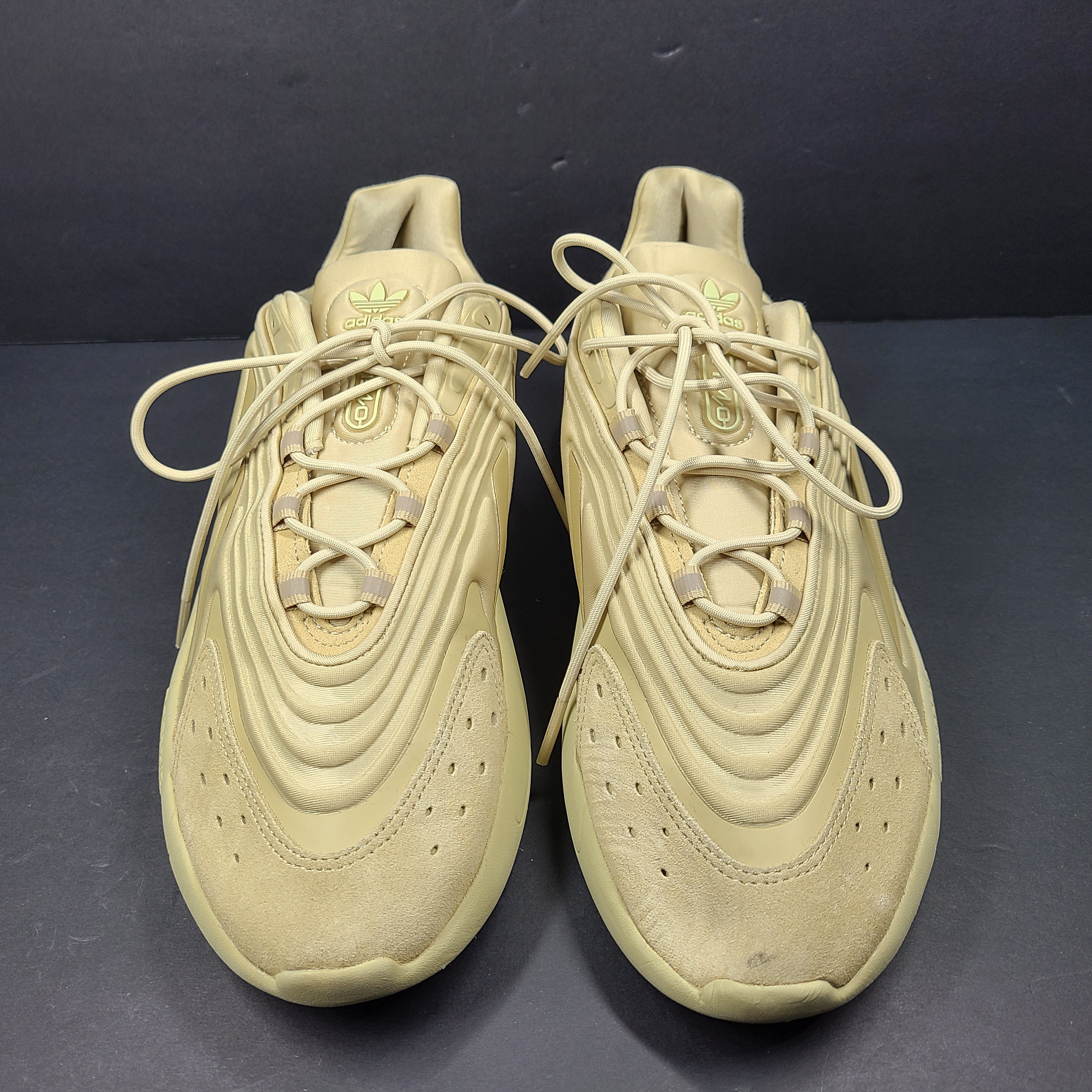 A pair of beige Adidas AdiPRENE GV7685 sneakers in size 10.