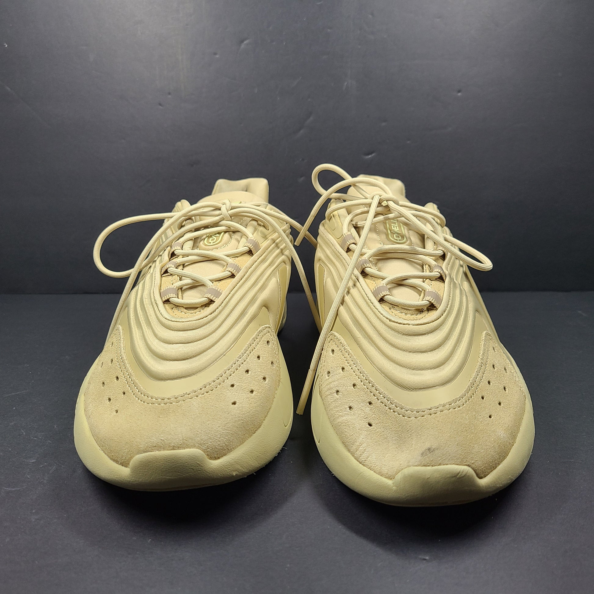 A pair of beige Adidas AdiPRENE GV7685 sneakers in size 10.