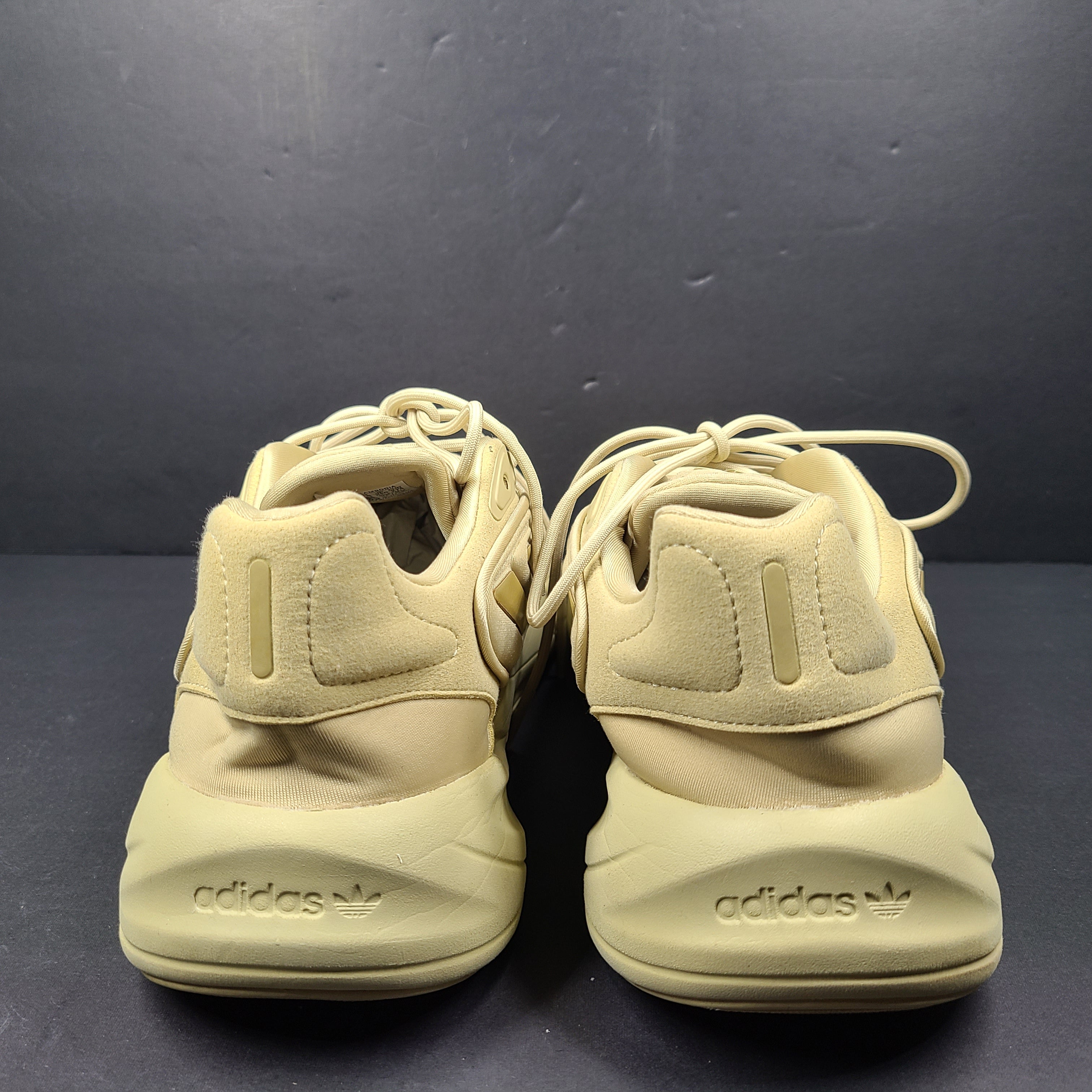 A pair of beige Adidas AdiPRENE GV7685 sneakers in size 10.