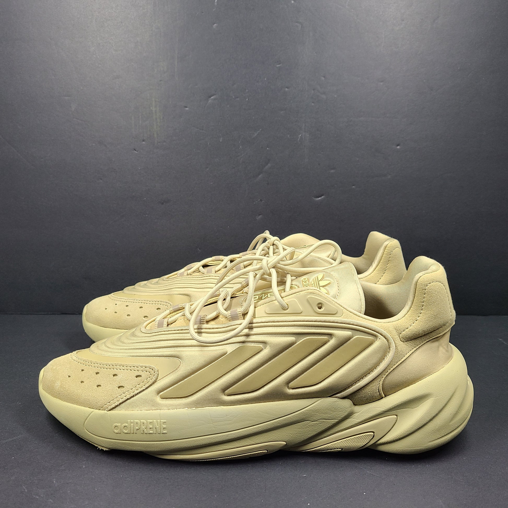 A pair of beige Adidas AdiPRENE GV7685 sneakers in size 10.