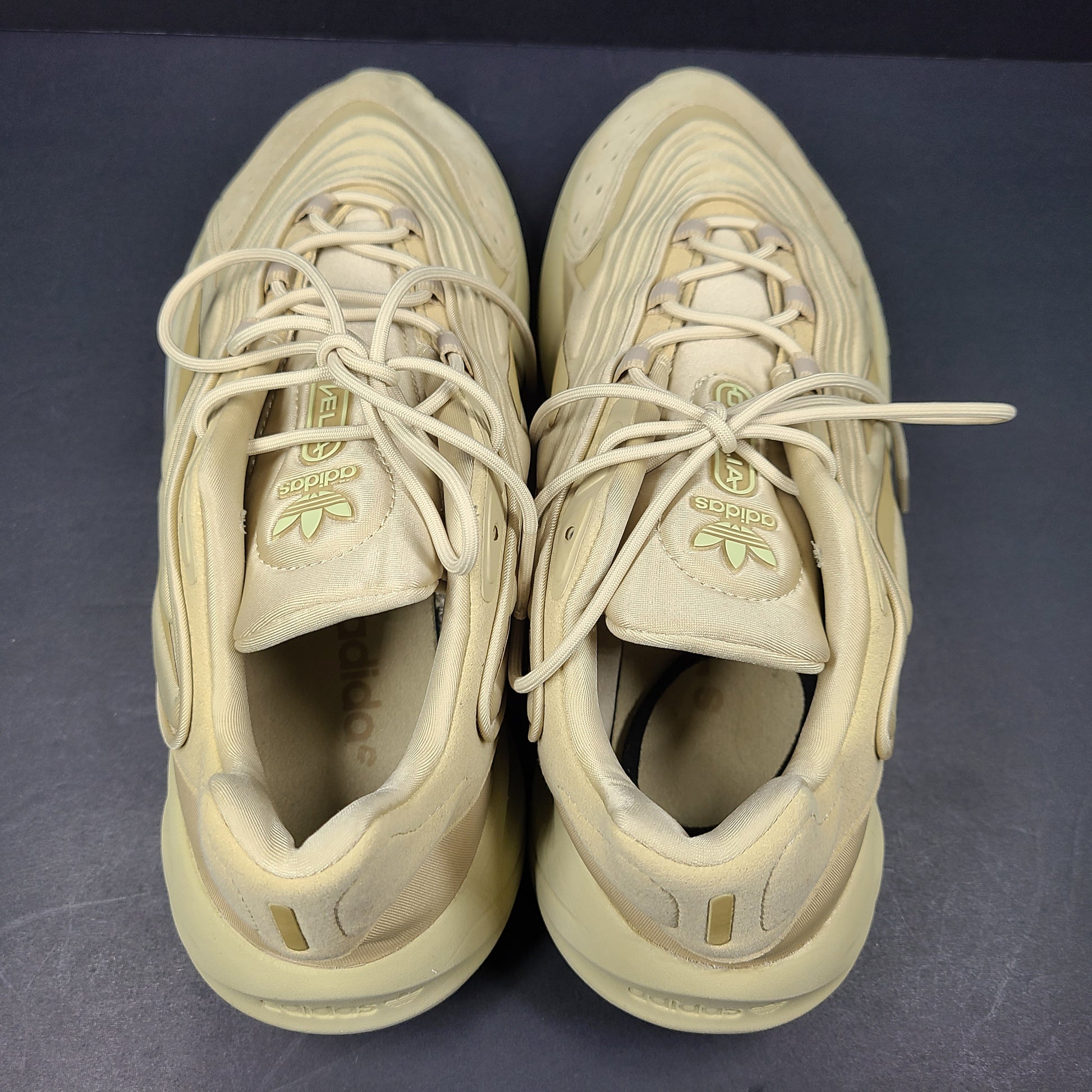 A pair of beige Adidas AdiPRENE GV7685 sneakers in size 10.