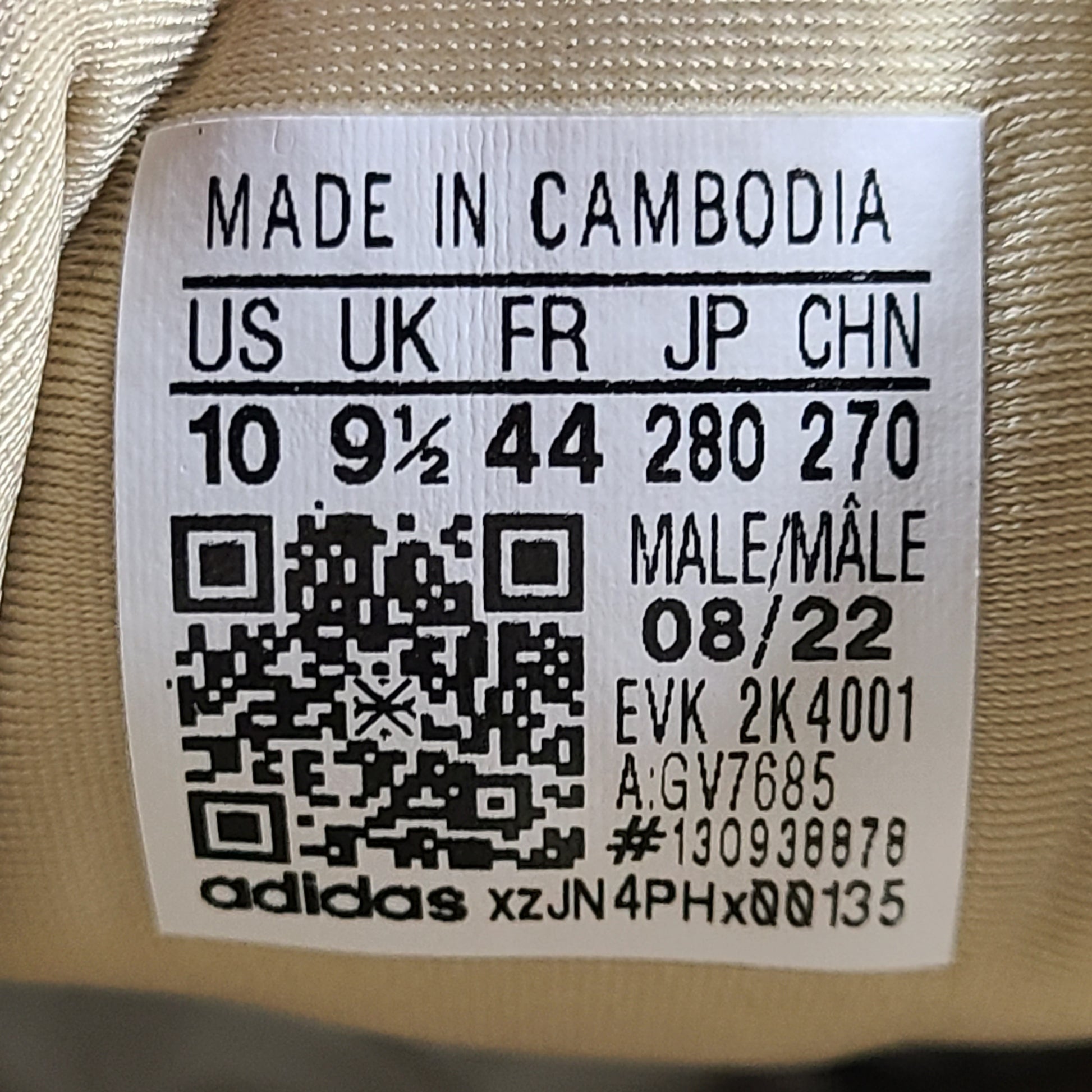 A pair of beige Adidas AdiPRENE GV7685 sneakers in size 10.
