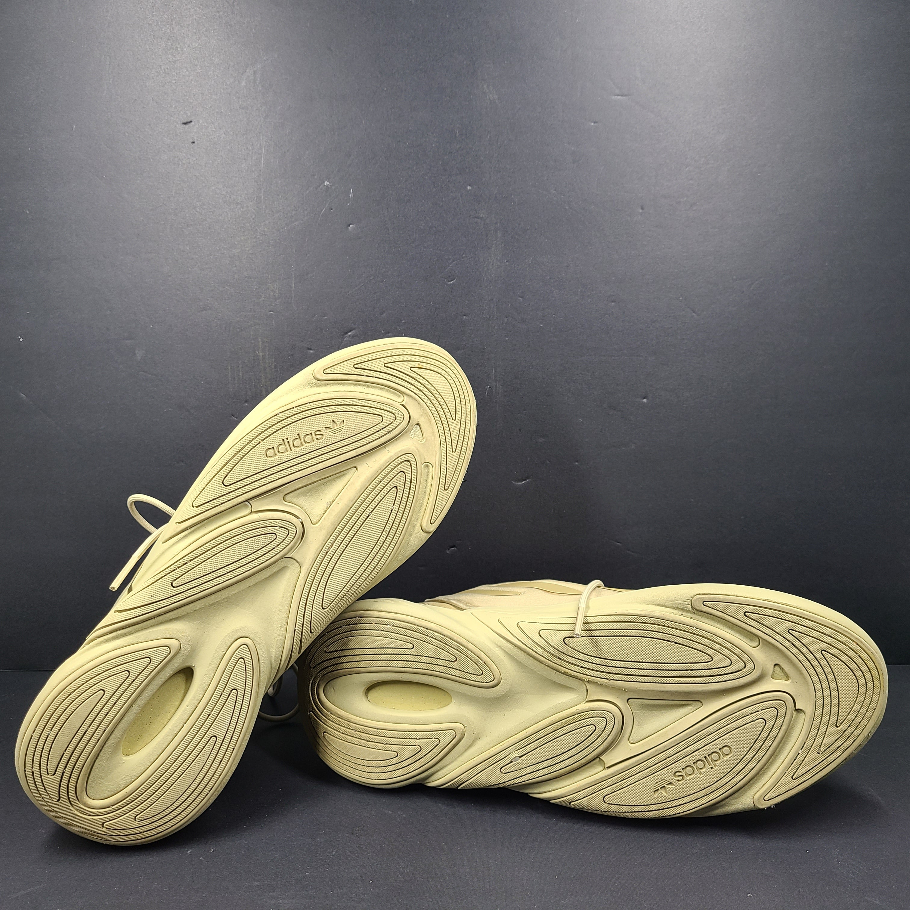 A pair of beige Adidas AdiPRENE GV7685 sneakers in size 10.