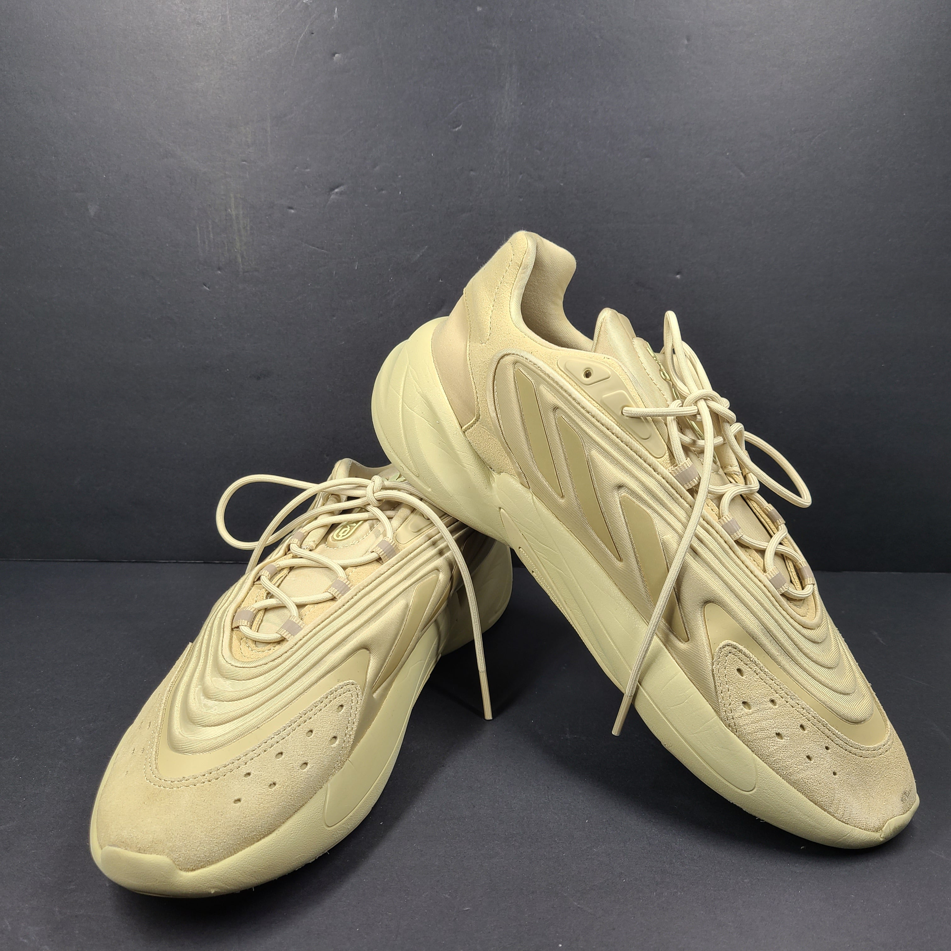 A pair of beige Adidas AdiPRENE GV7685 sneakers in size 10.