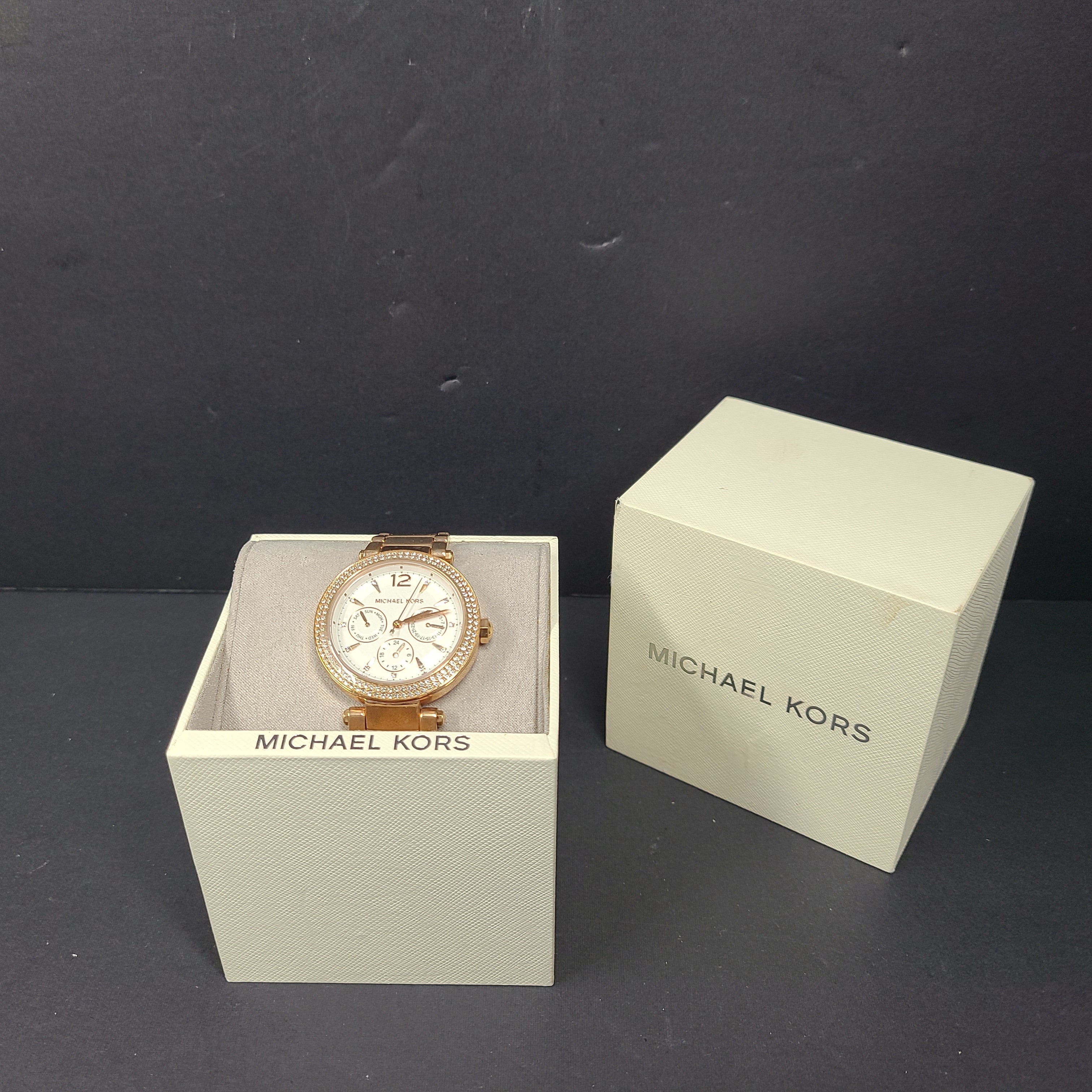 A stylish Michael Kors women's rose gold watch with stainless steel strap.