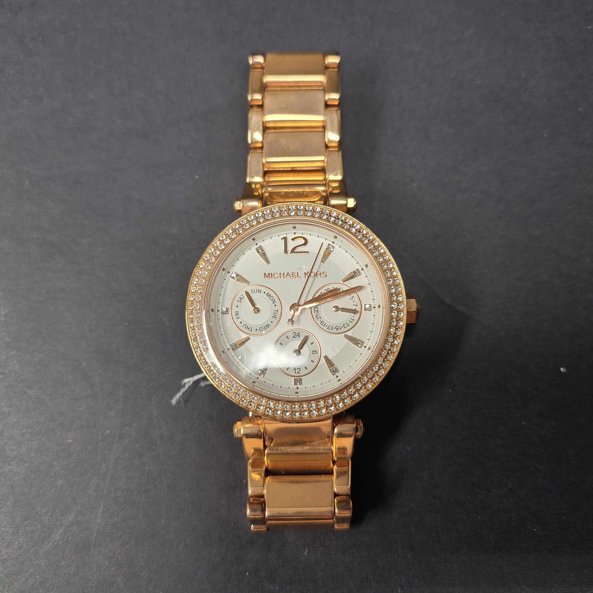 A stylish Michael Kors women's rose gold watch with stainless steel strap.