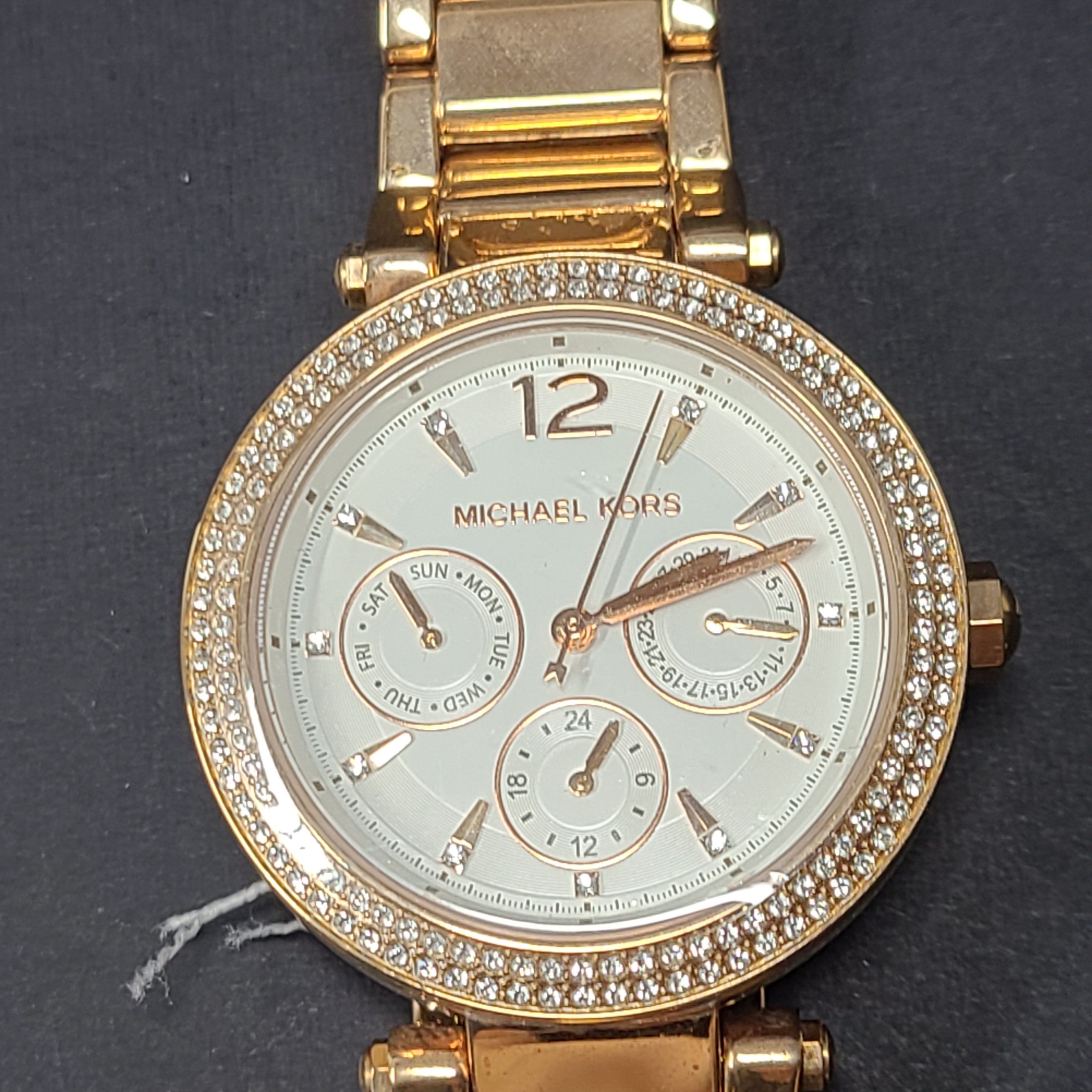 A stylish Michael Kors women's rose gold watch with stainless steel strap.