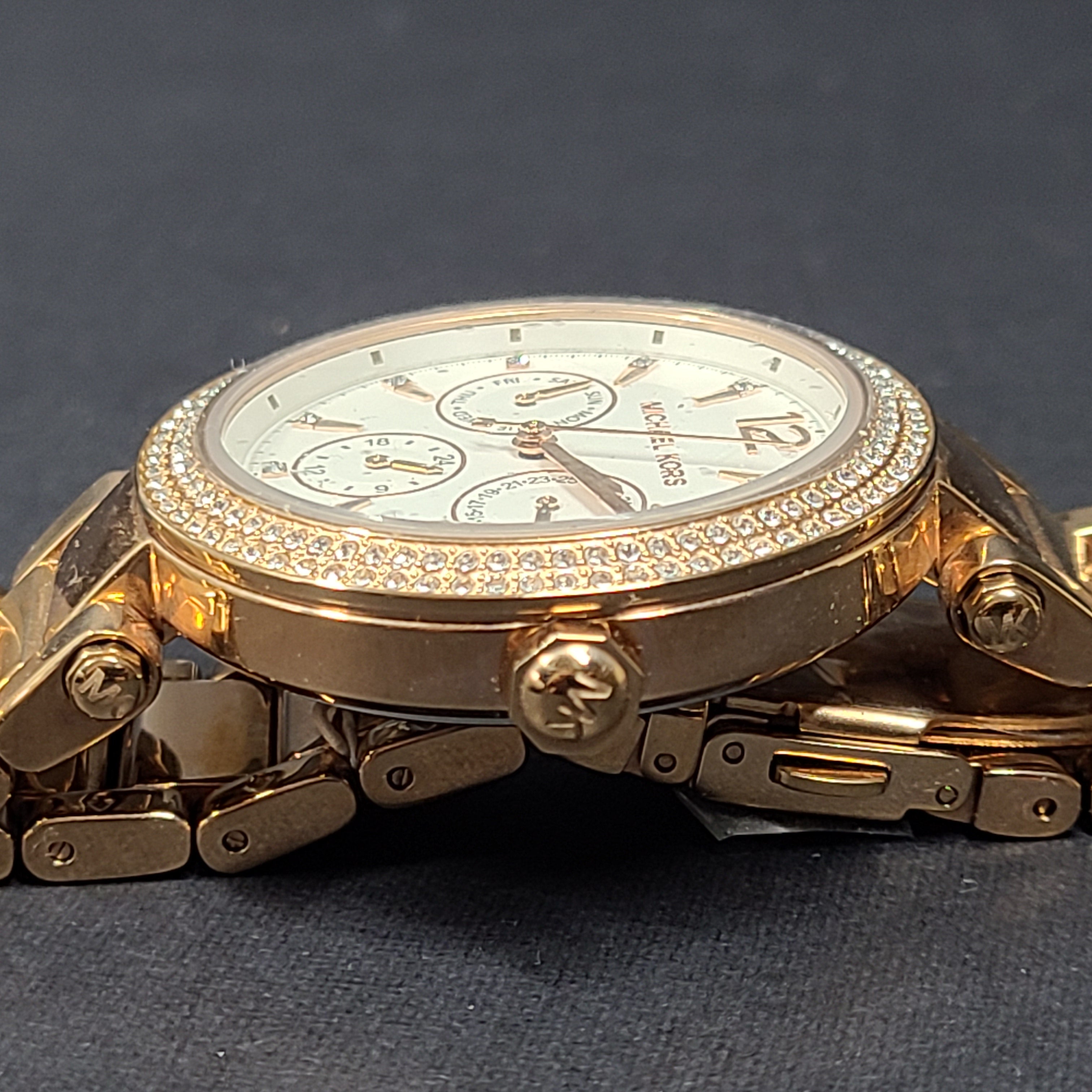 A stylish Michael Kors women's rose gold watch with stainless steel strap.