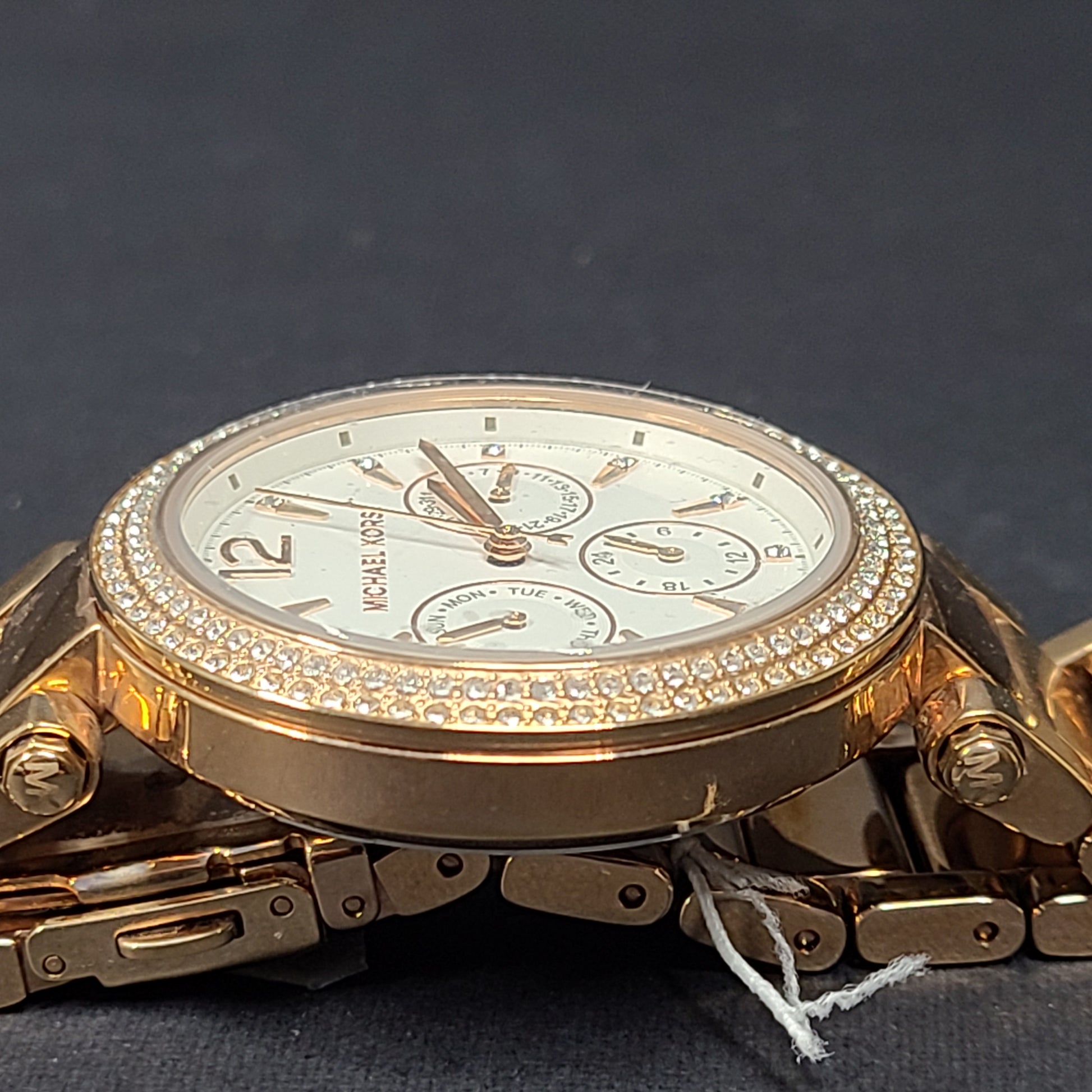 A stylish Michael Kors women's rose gold watch with stainless steel strap.