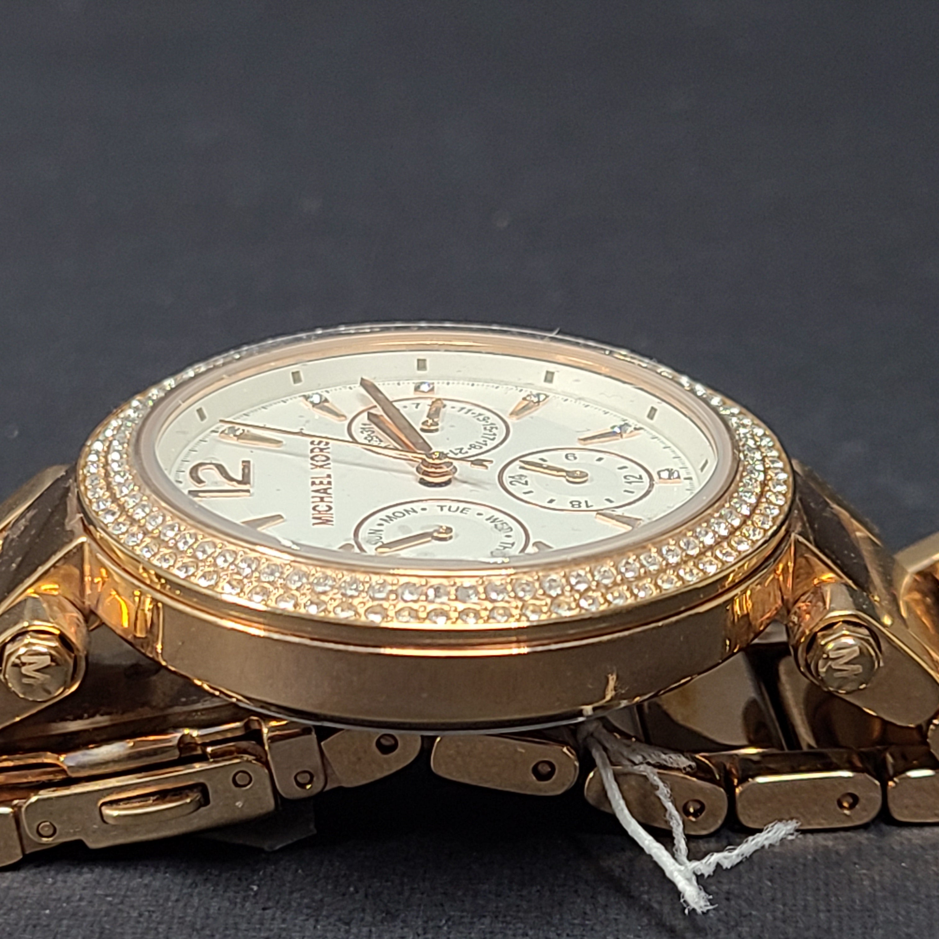 A stylish Michael Kors women's rose gold watch with stainless steel strap.