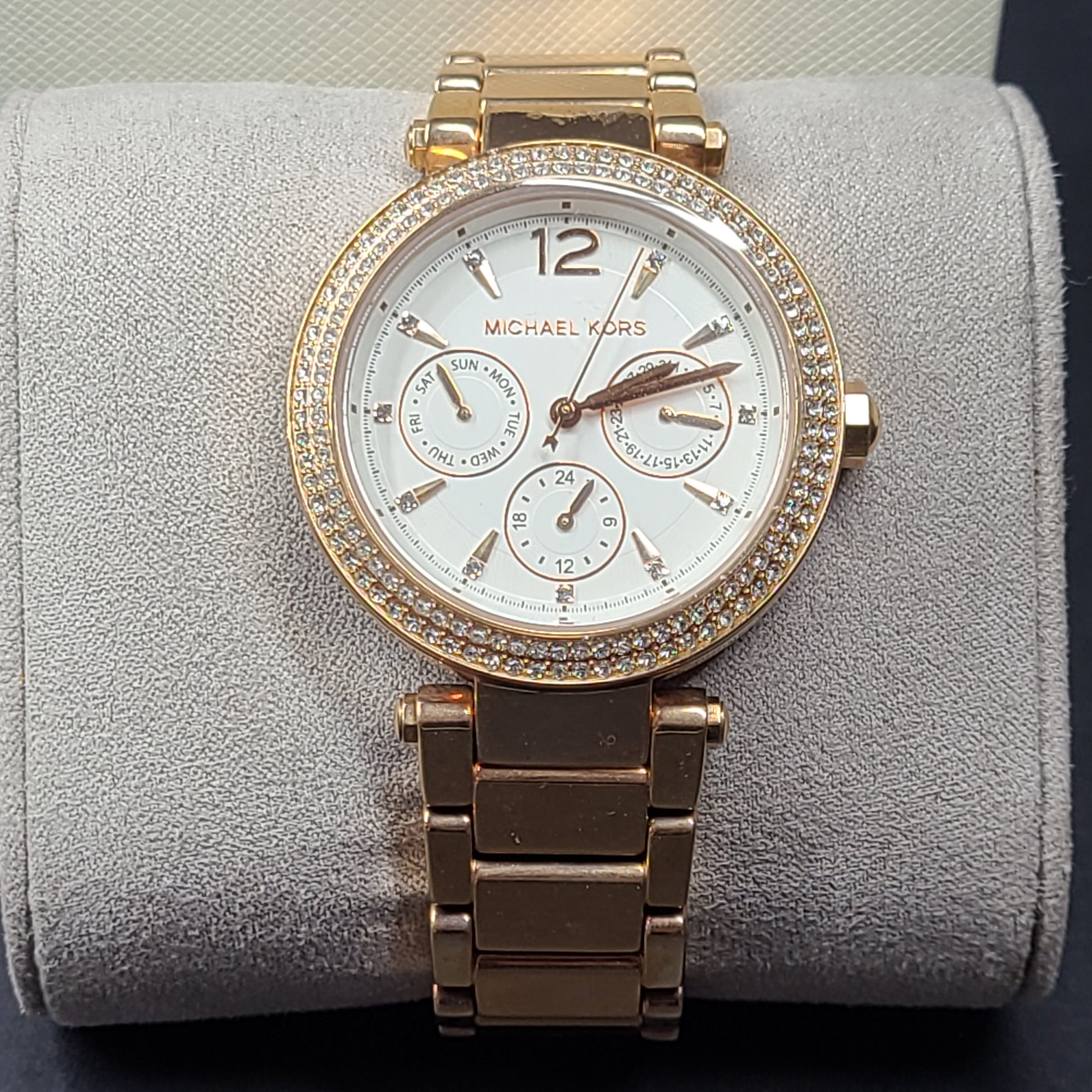 A stylish Michael Kors women's rose gold watch with stainless steel strap.