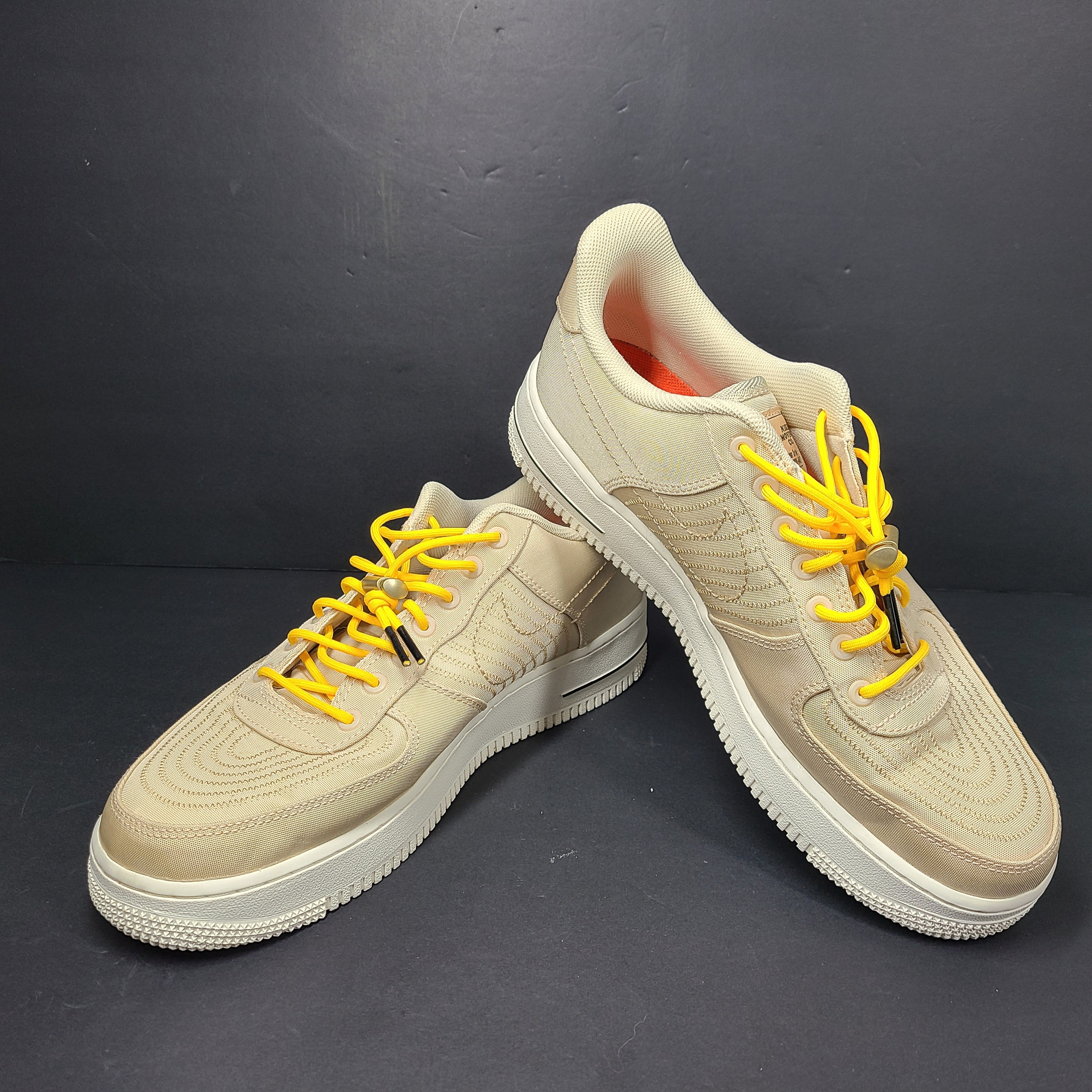 A pair of men's Nike Air Force 1 Low Beige sneakers.