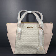 Light pink and logo canvas Michael Kors tote bag with gold zip and side pockets, shown with handles