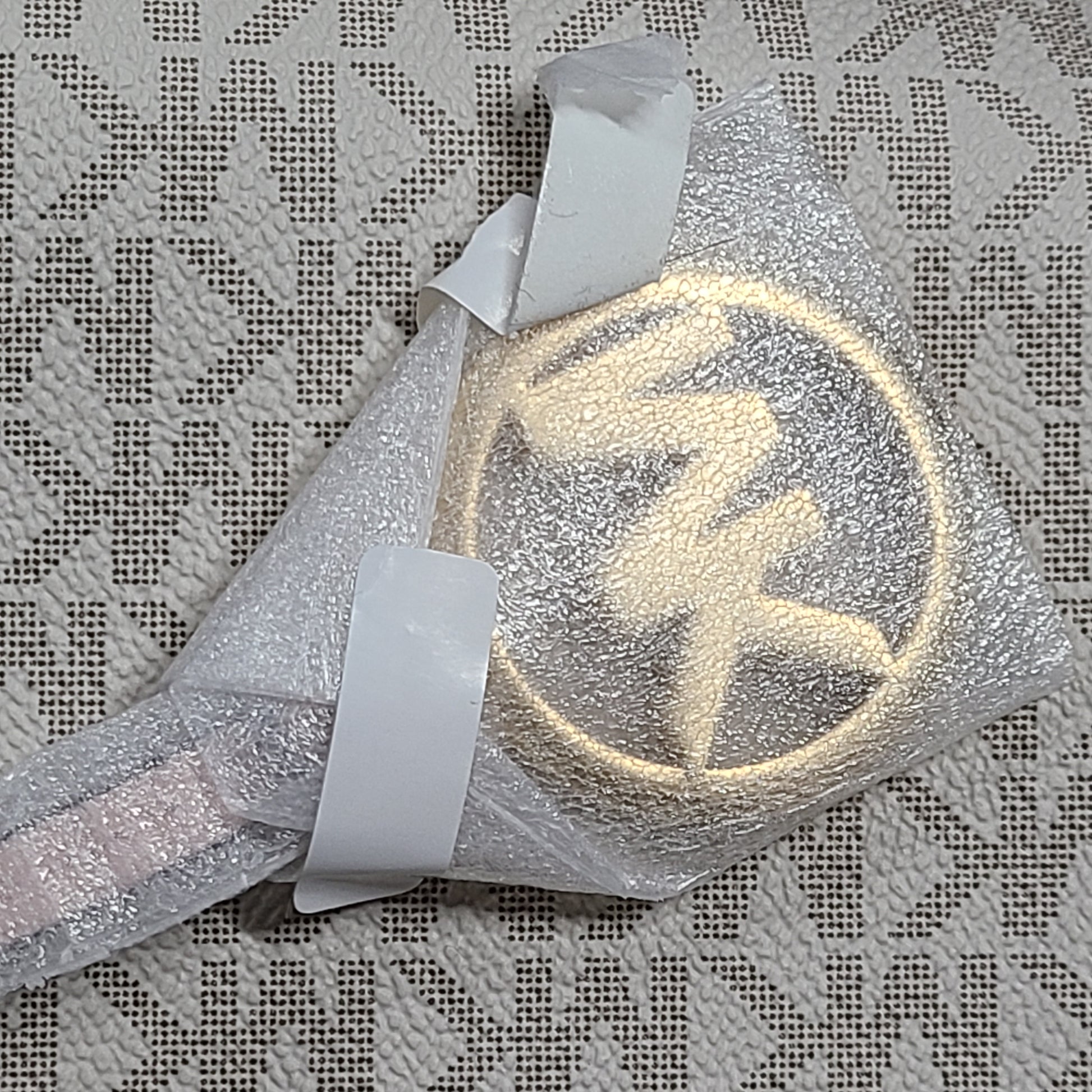 Light pink and logo canvas Michael Kors tote bag with gold zip and side pockets, shown with handles