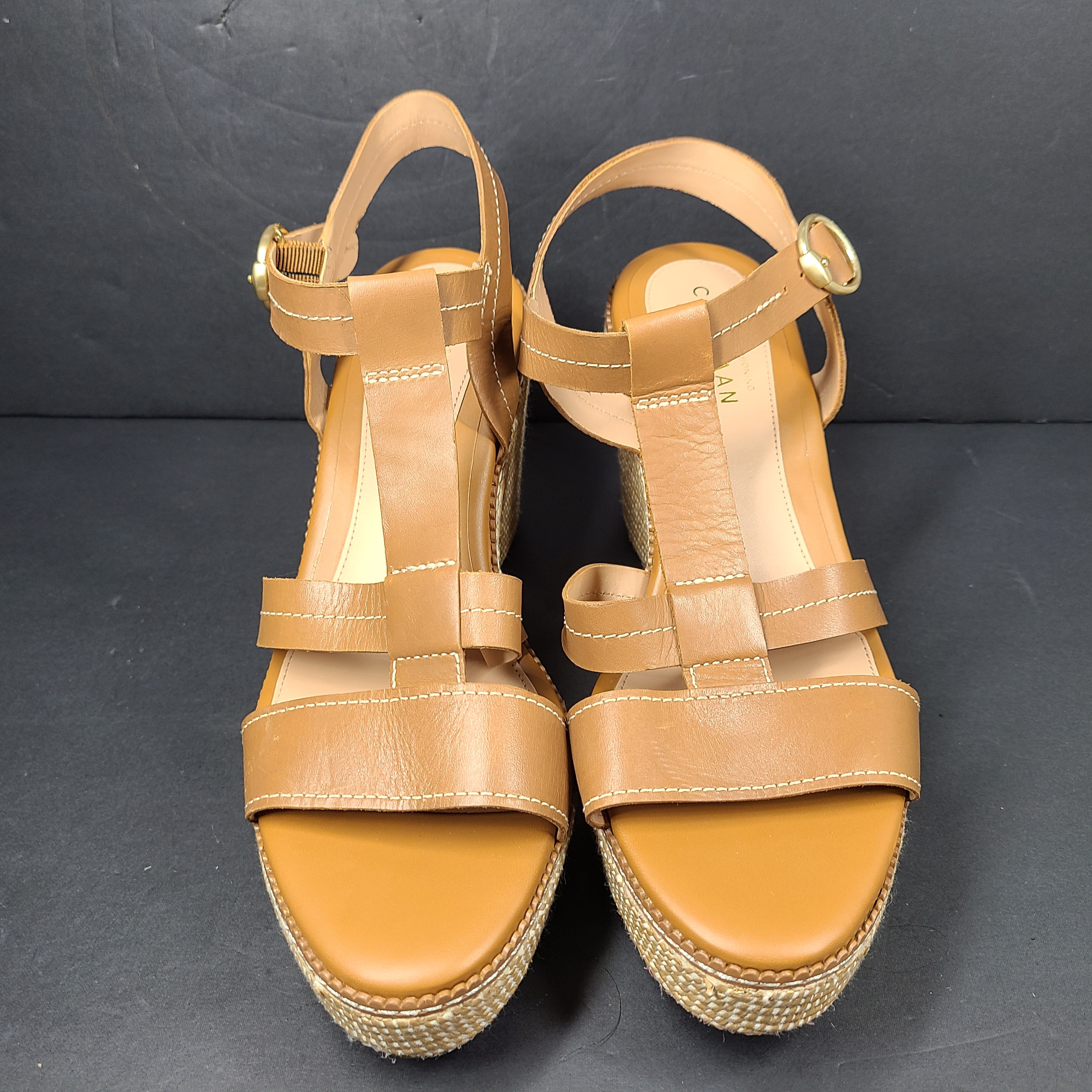 A pair of tan Cole Haan Cloudfeel Grandseries wedge sandals for women