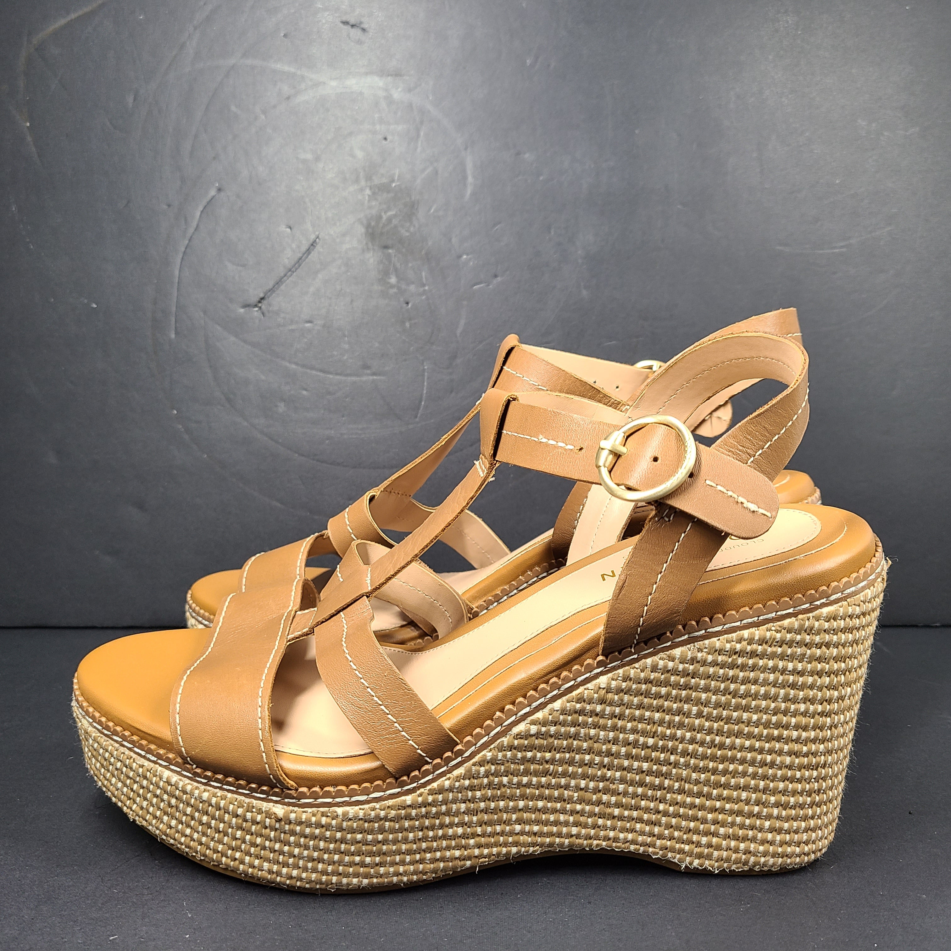 A pair of tan Cole Haan Cloudfeel Grandseries wedge sandals for women