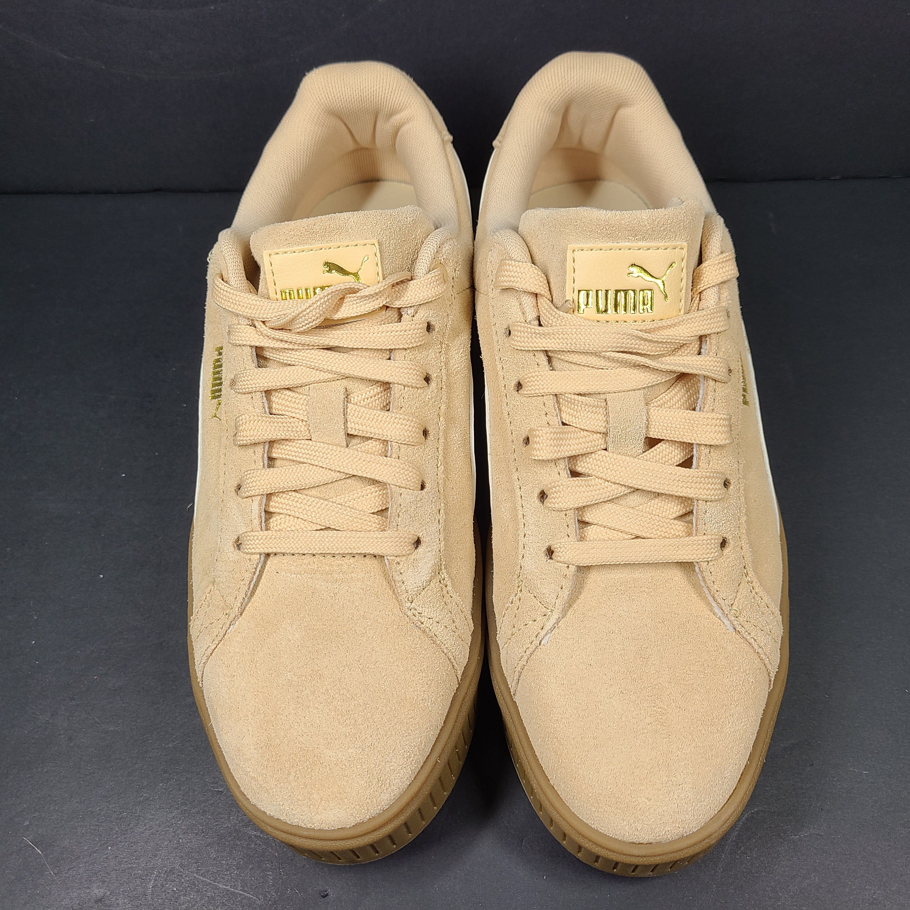 A pair of beige Puma Women's Suede Platform Sneakers.