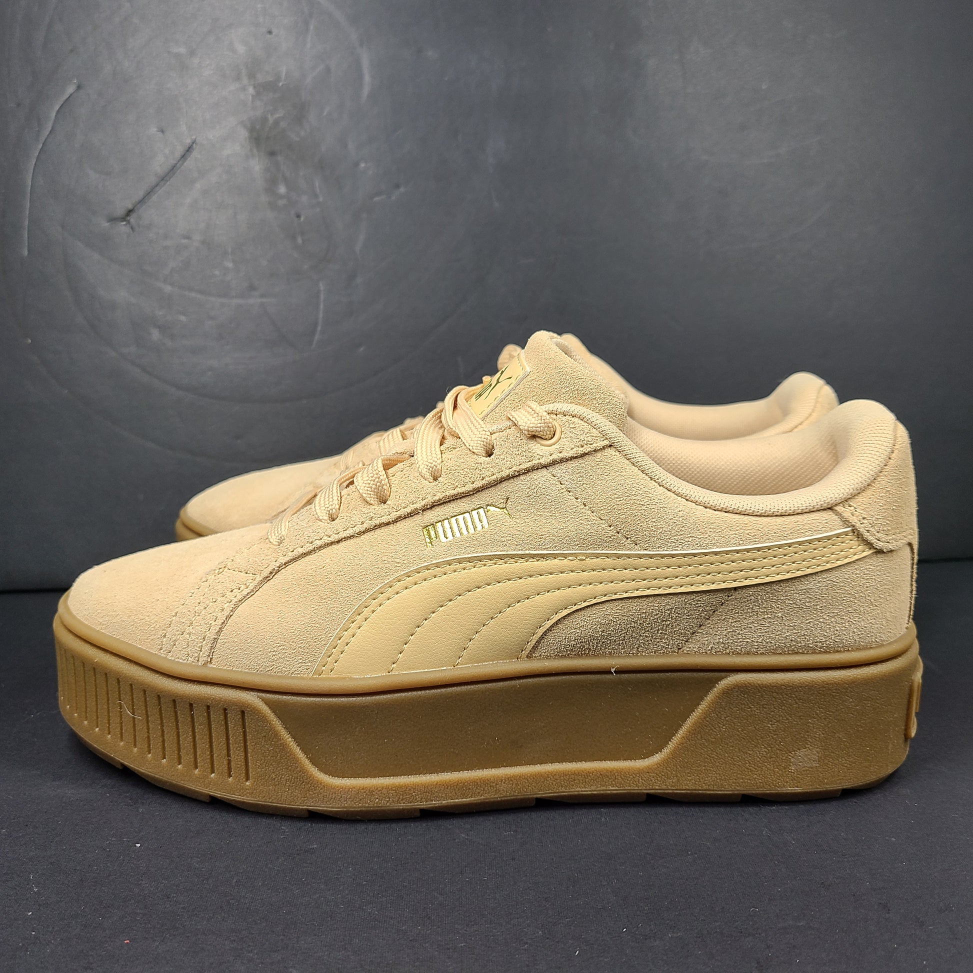 A pair of beige Puma Women's Suede Platform Sneakers.