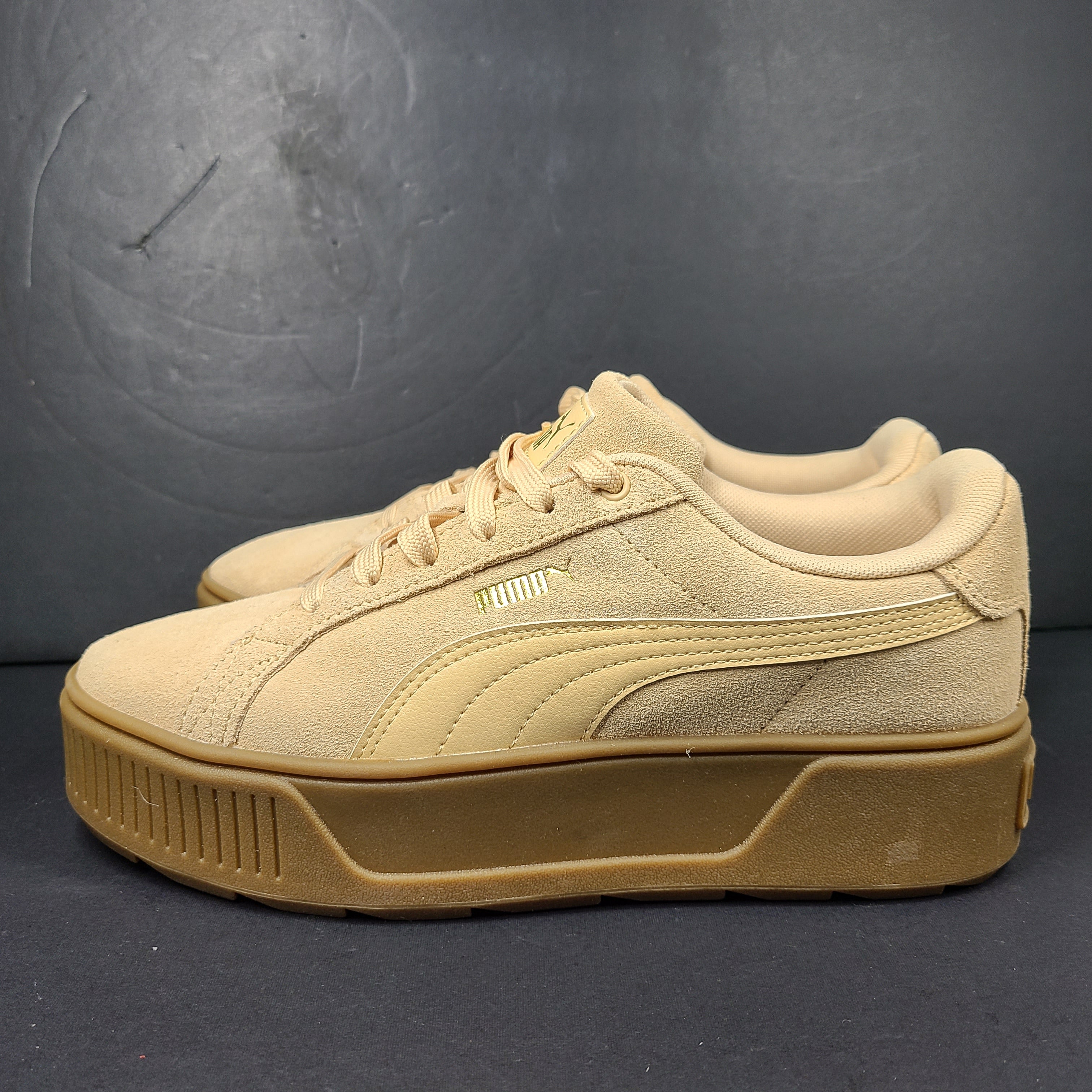 A pair of beige Puma Women's Suede Platform Sneakers.