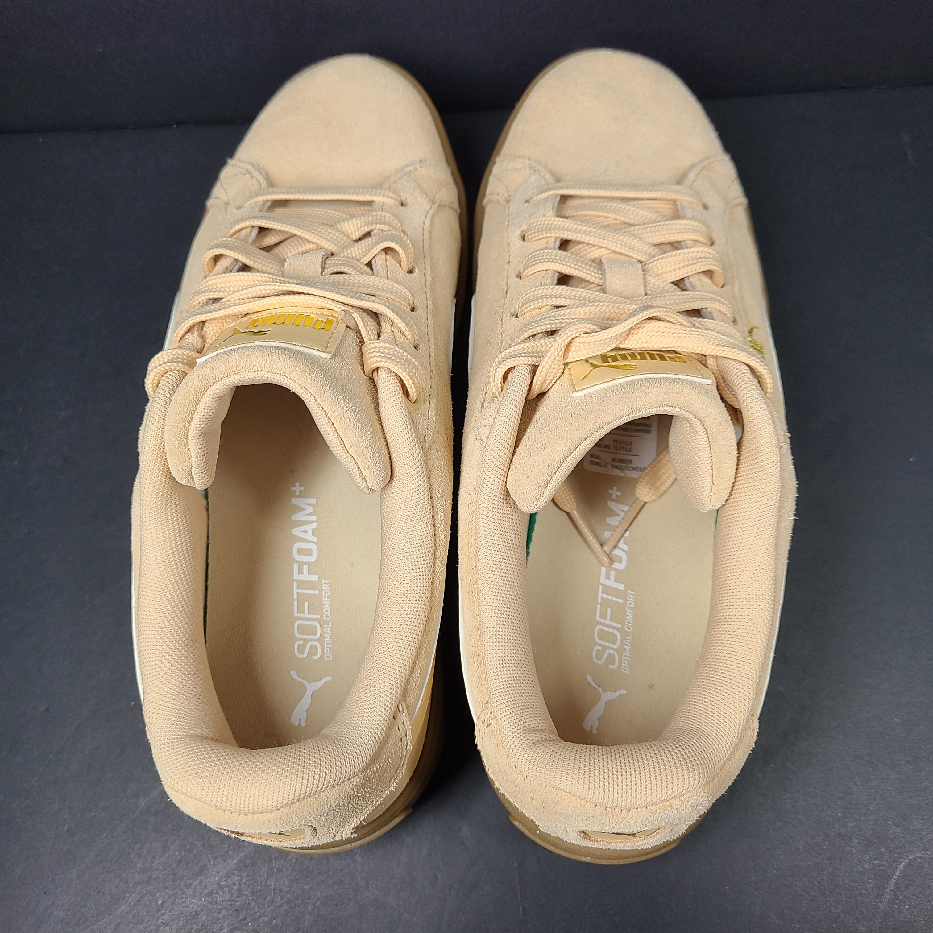 A pair of beige Puma Women's Suede Platform Sneakers.
