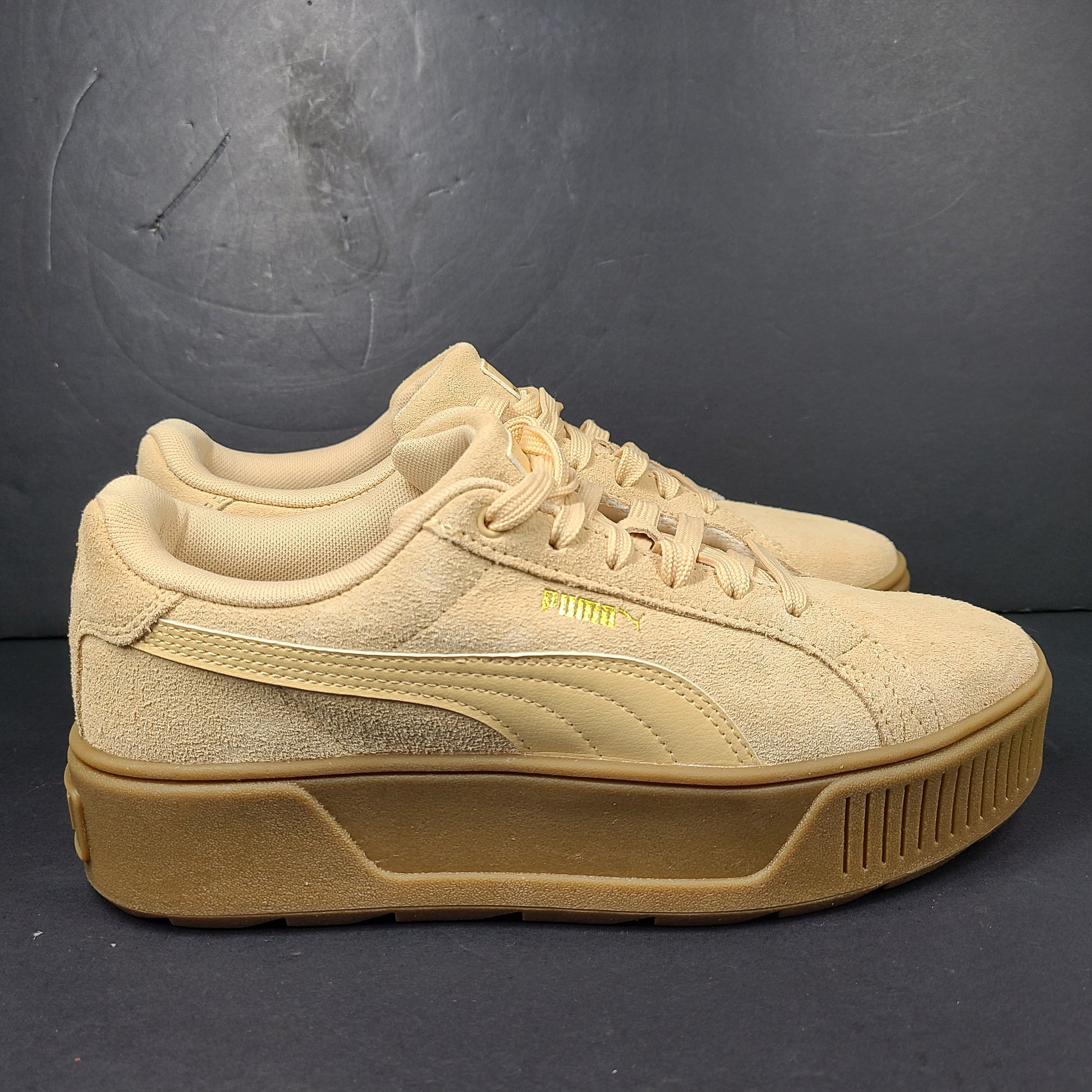 A pair of beige Puma Women's Suede Platform Sneakers.