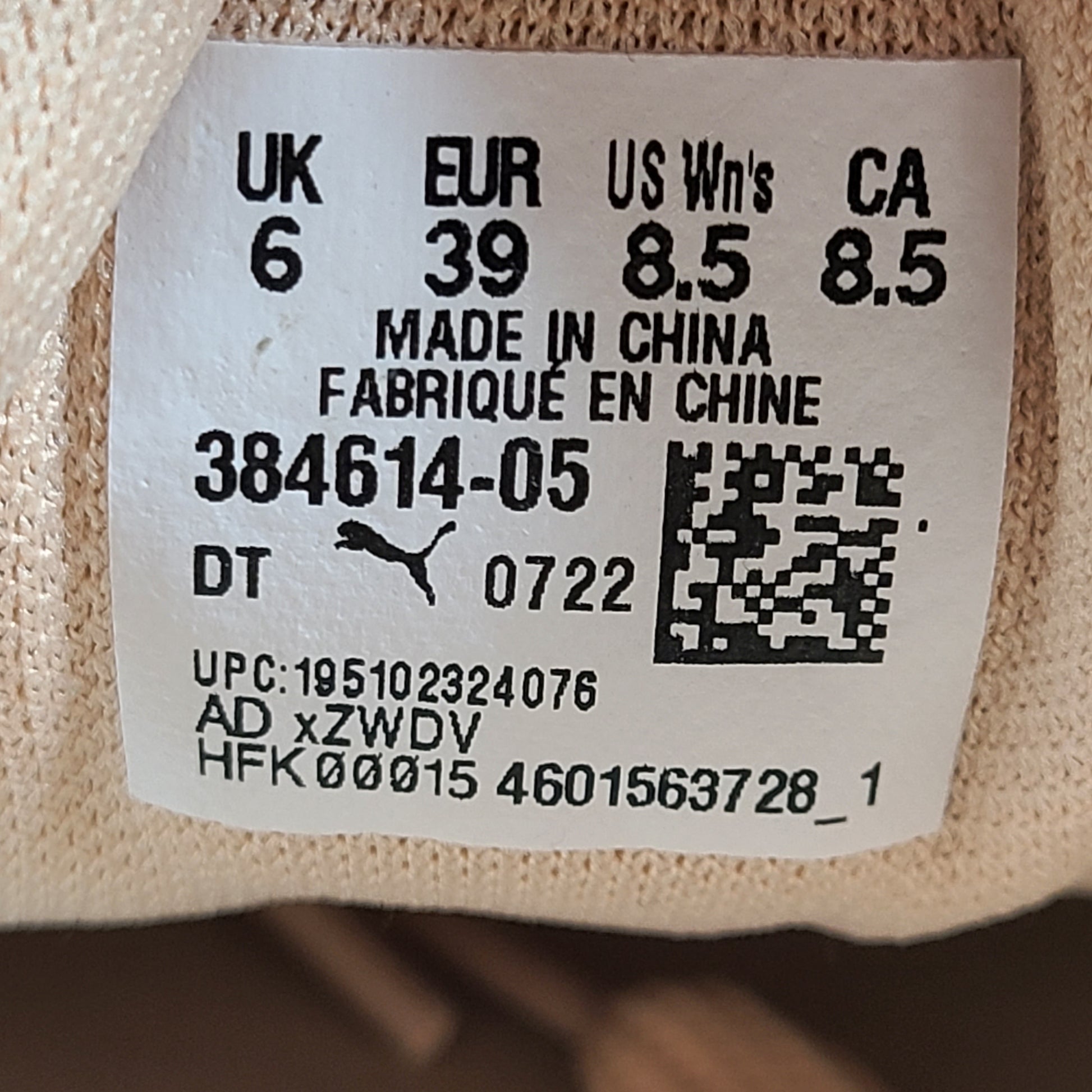 A pair of beige Puma Women's Suede Platform Sneakers.