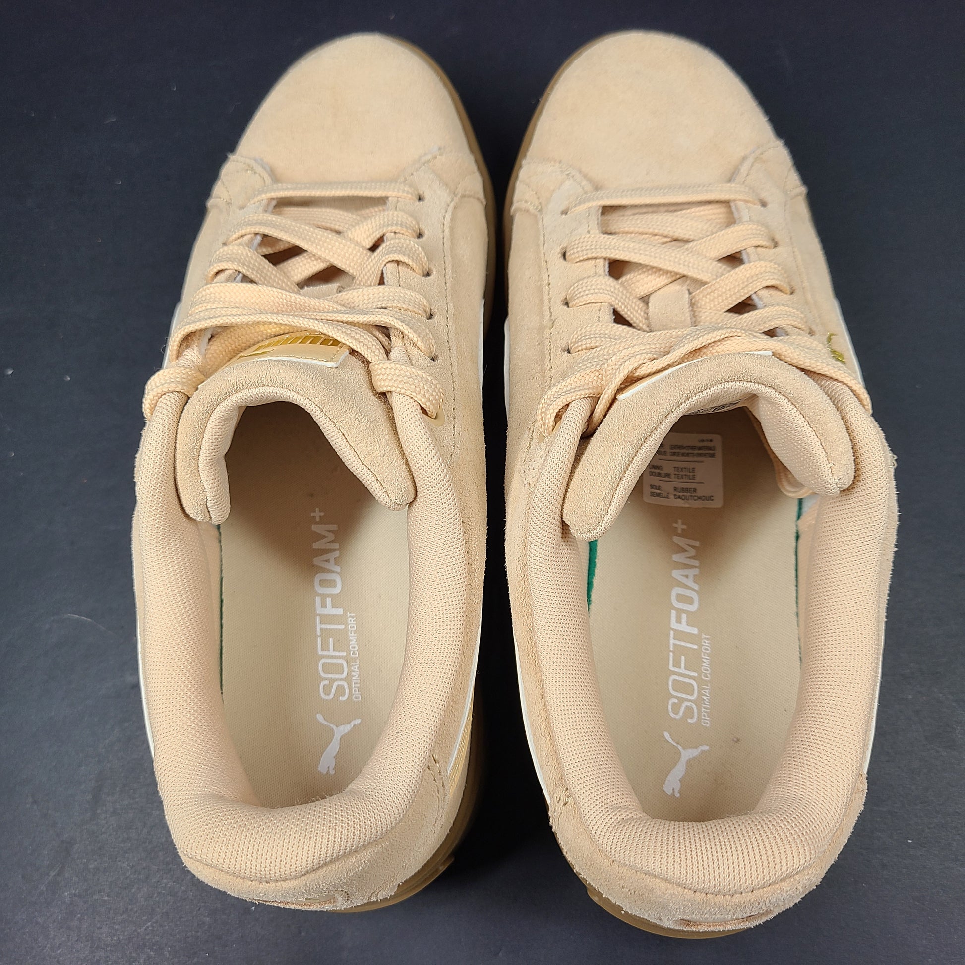 A pair of beige Puma Women's Suede Platform Sneakers.