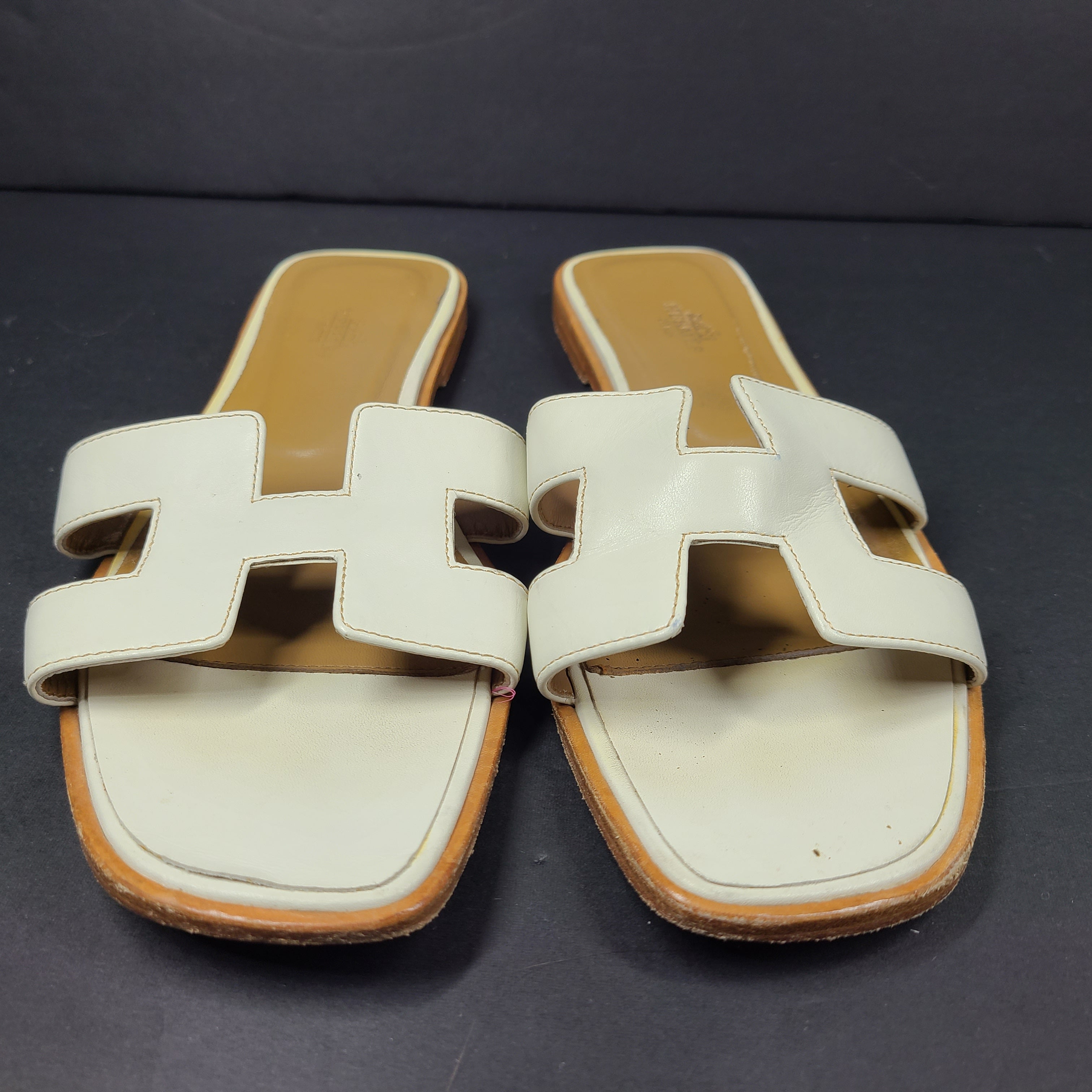 A pair of white leather Hermès Oran sandals with size 41 embossed in Italy