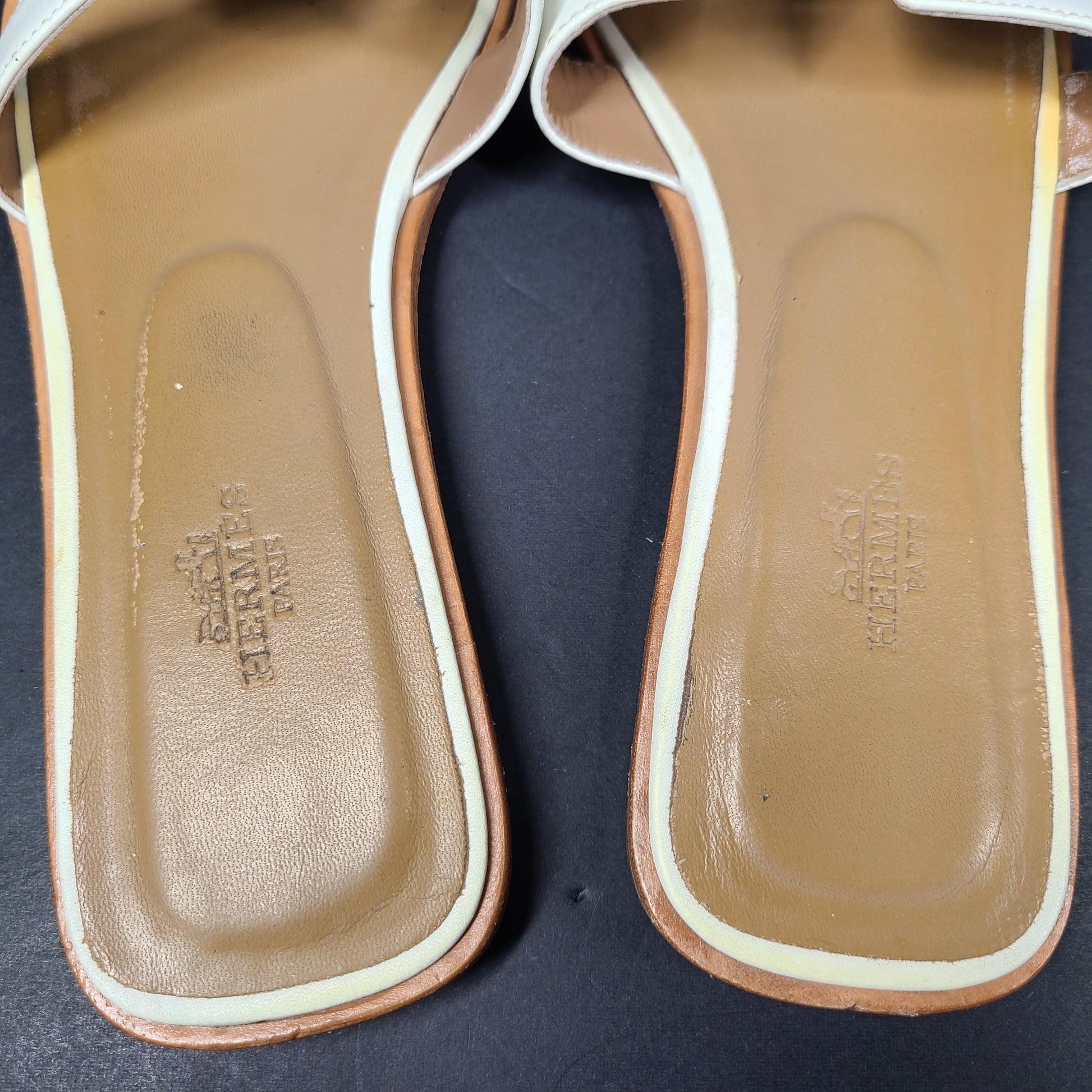 A pair of white leather Hermès Oran sandals with size 41 embossed in Italy