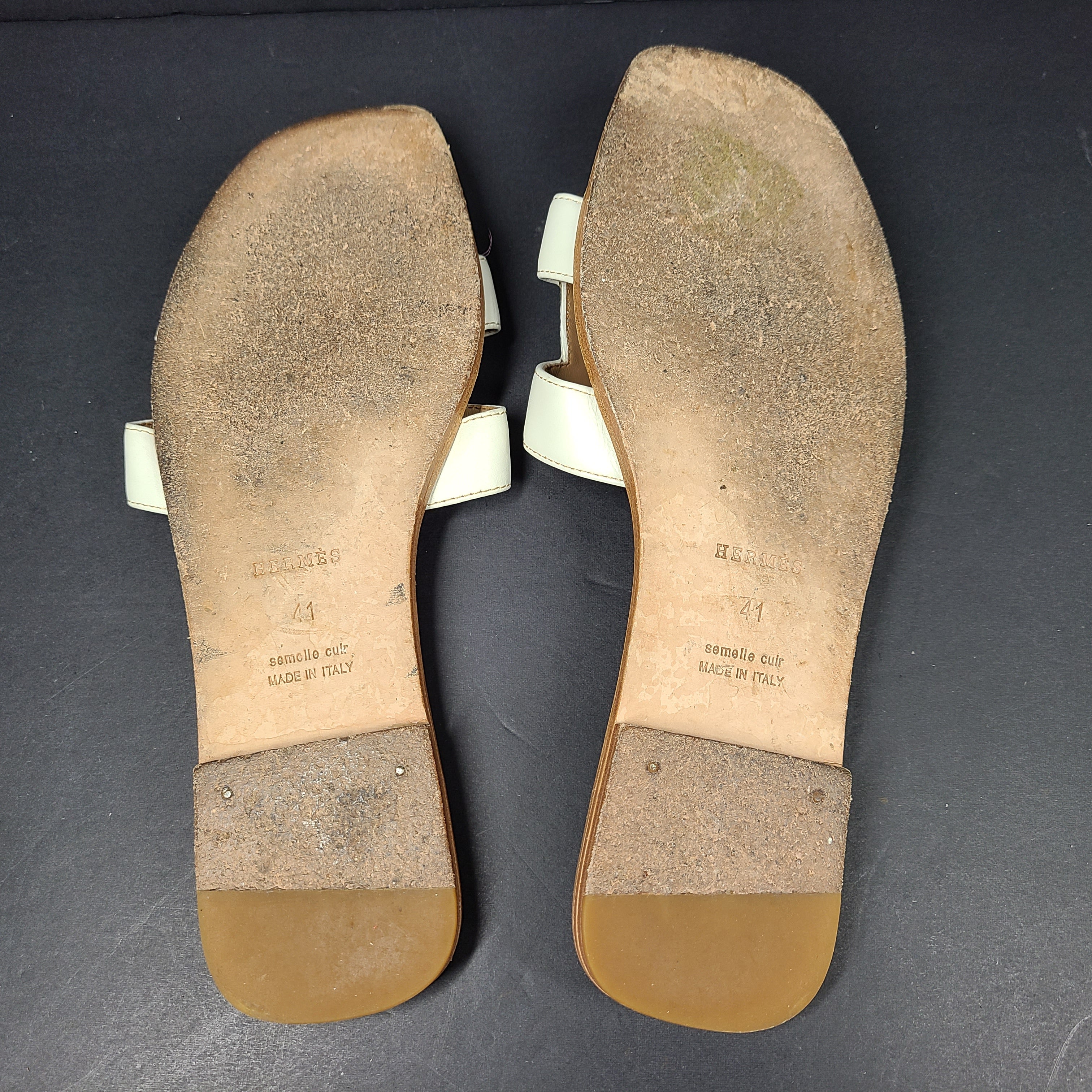 A pair of white leather Hermès Oran sandals with size 41 embossed in Italy
