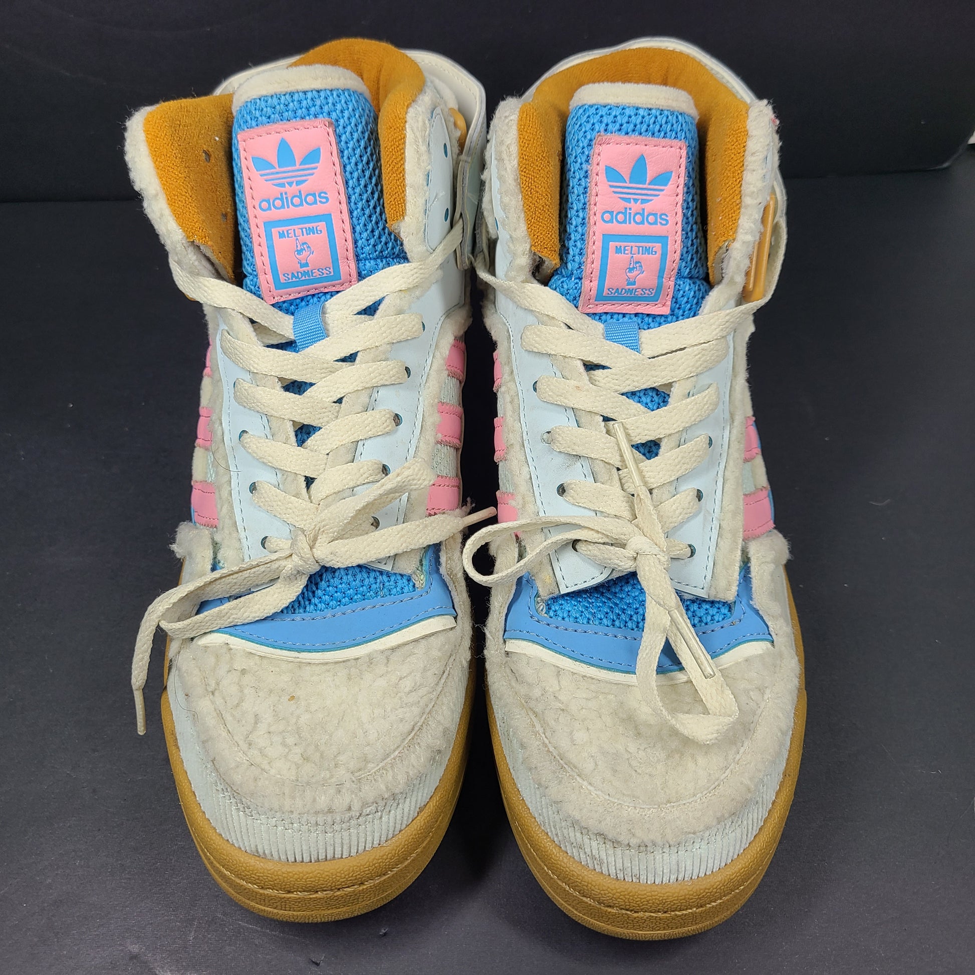 A pair of multicolor Adidas sneakers with artistic design