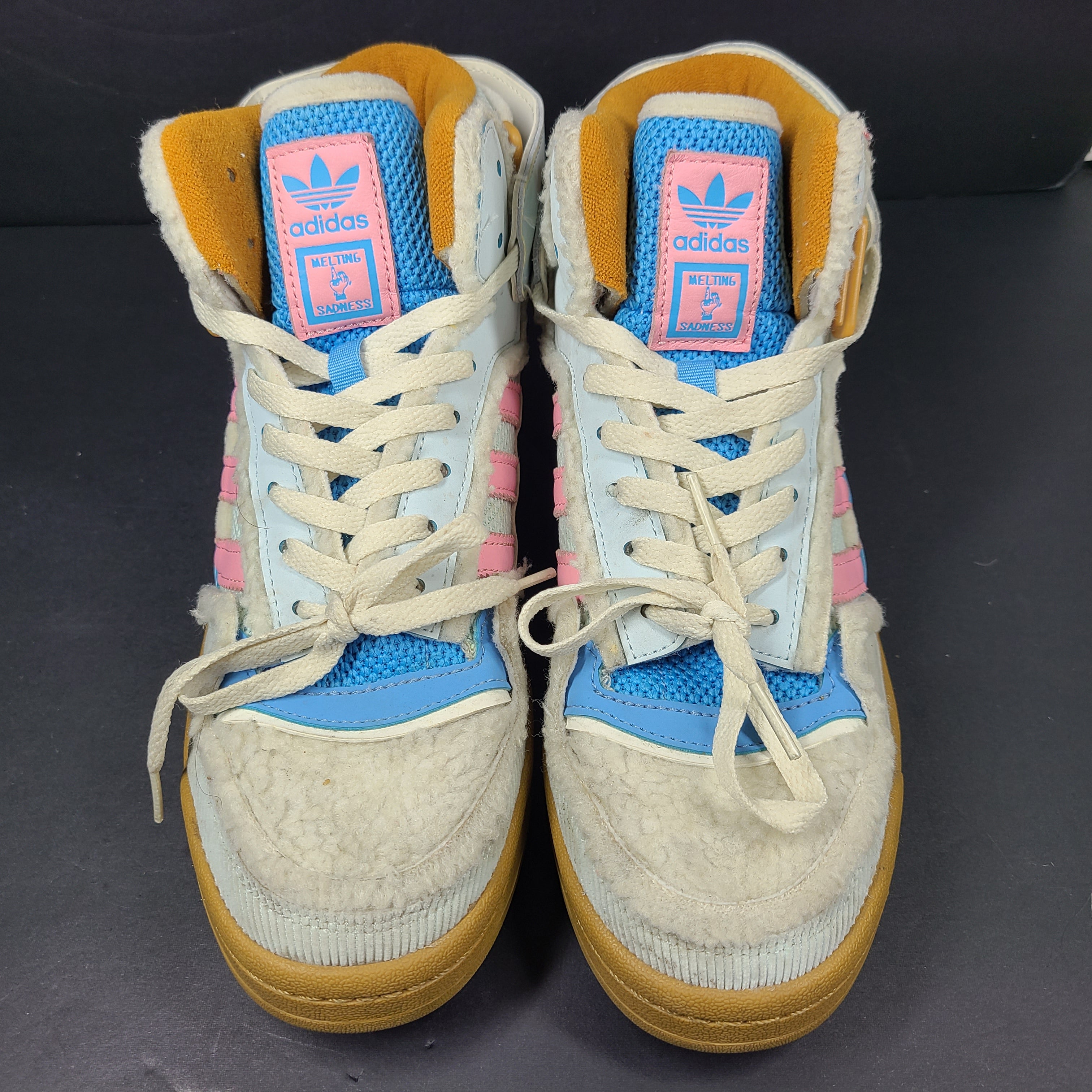 A pair of multicolor Adidas sneakers with artistic design