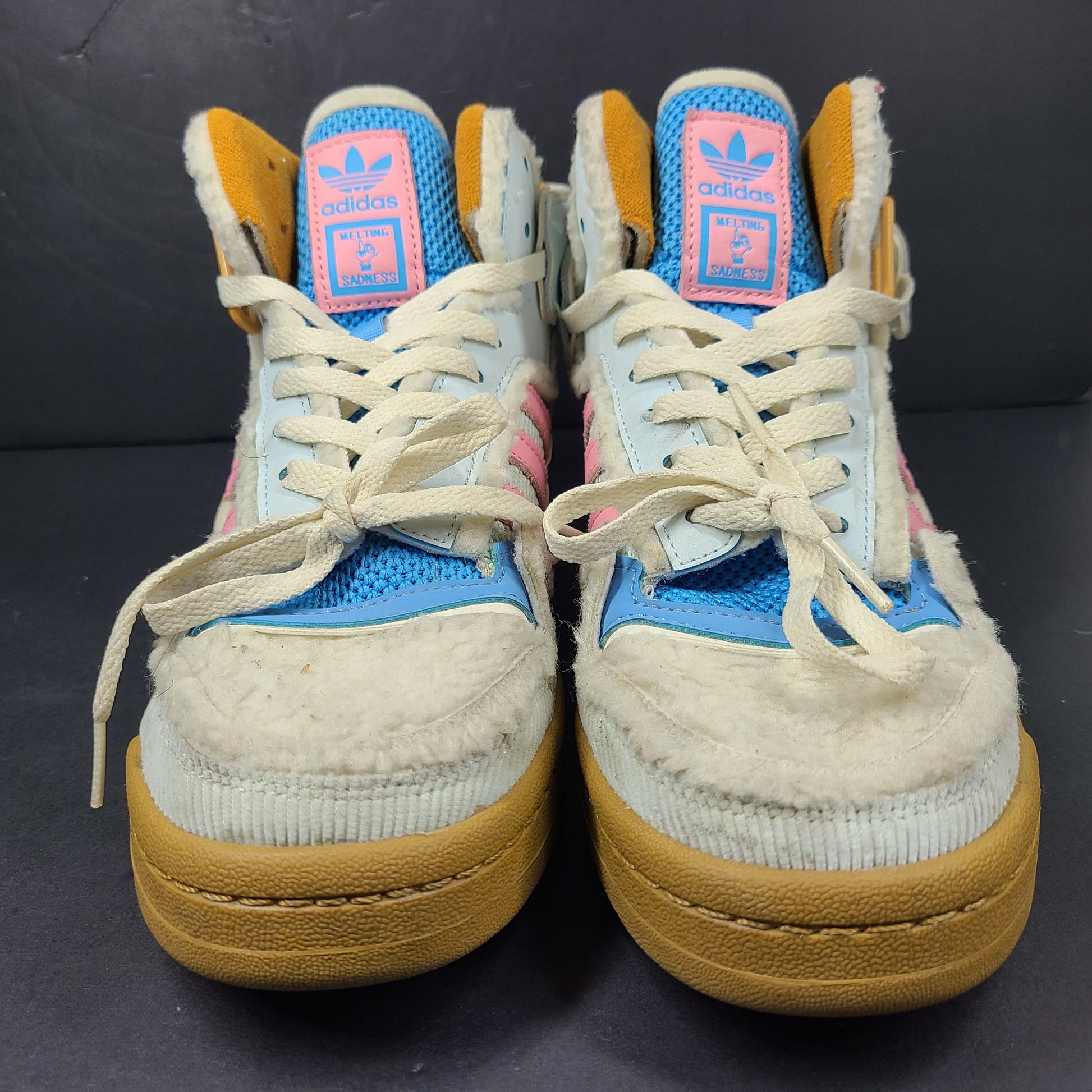 A pair of multicolor Adidas sneakers with artistic design