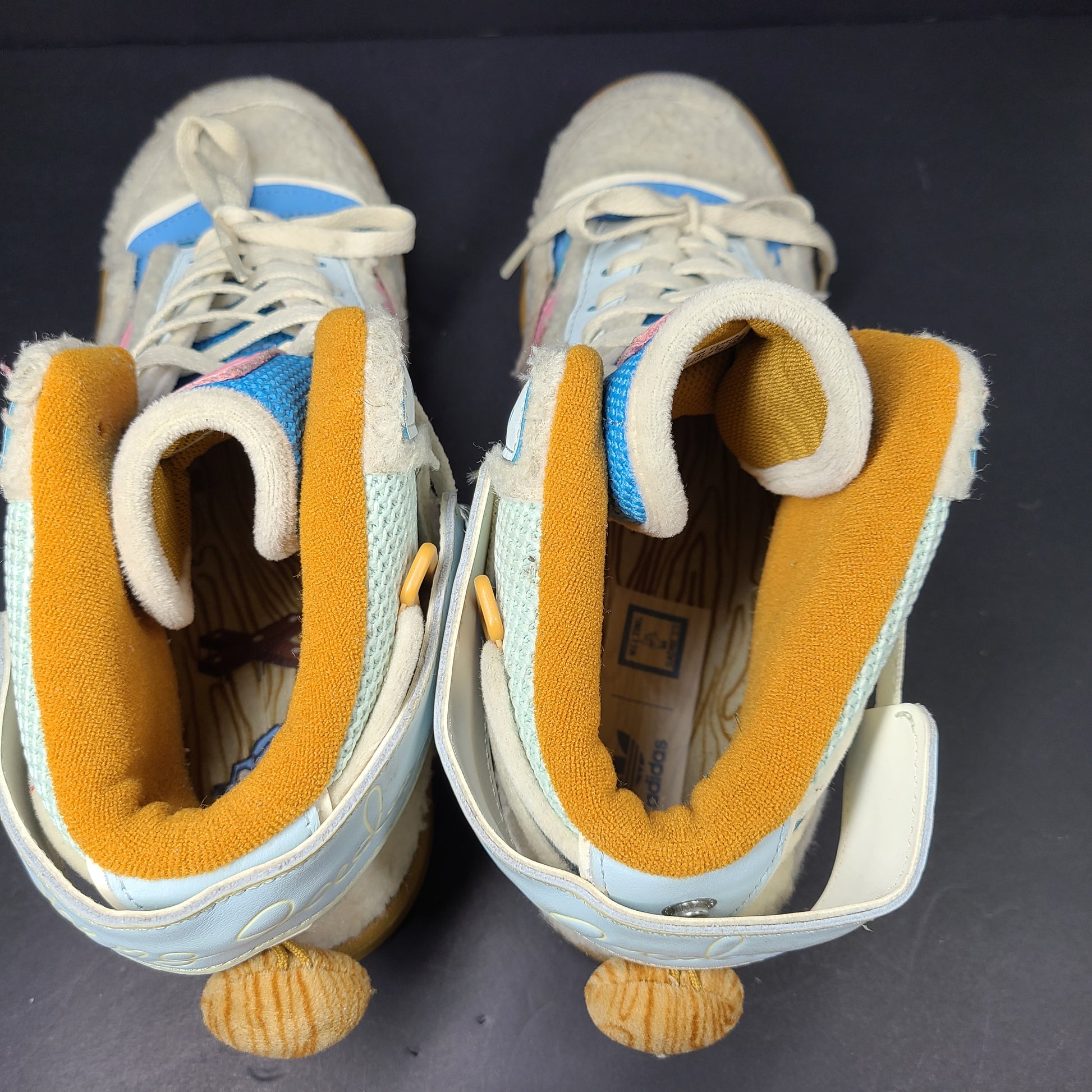 A pair of multicolor Adidas sneakers with artistic design