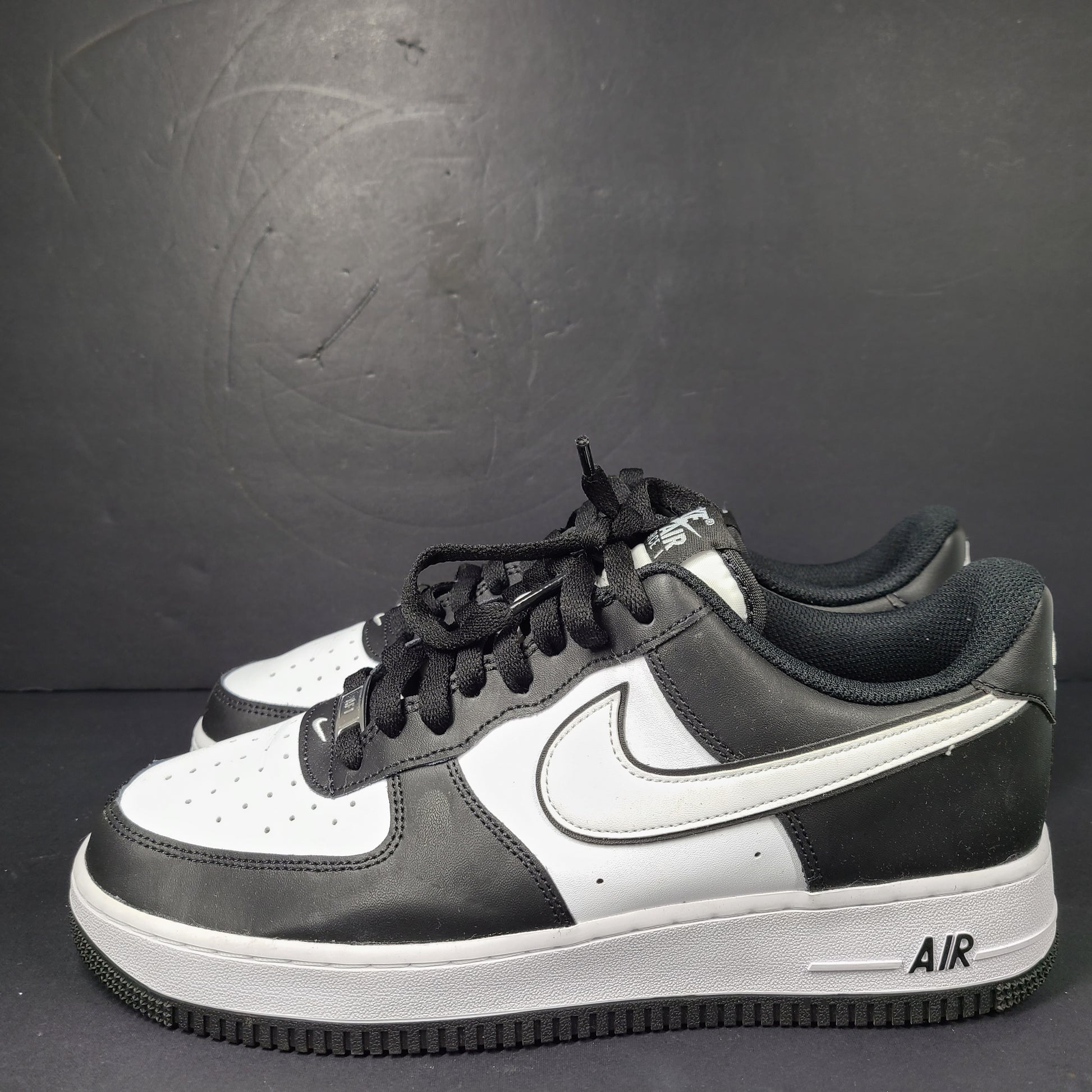 A stylish pair of Nike Air Force 1 Low sneakers in black and white.