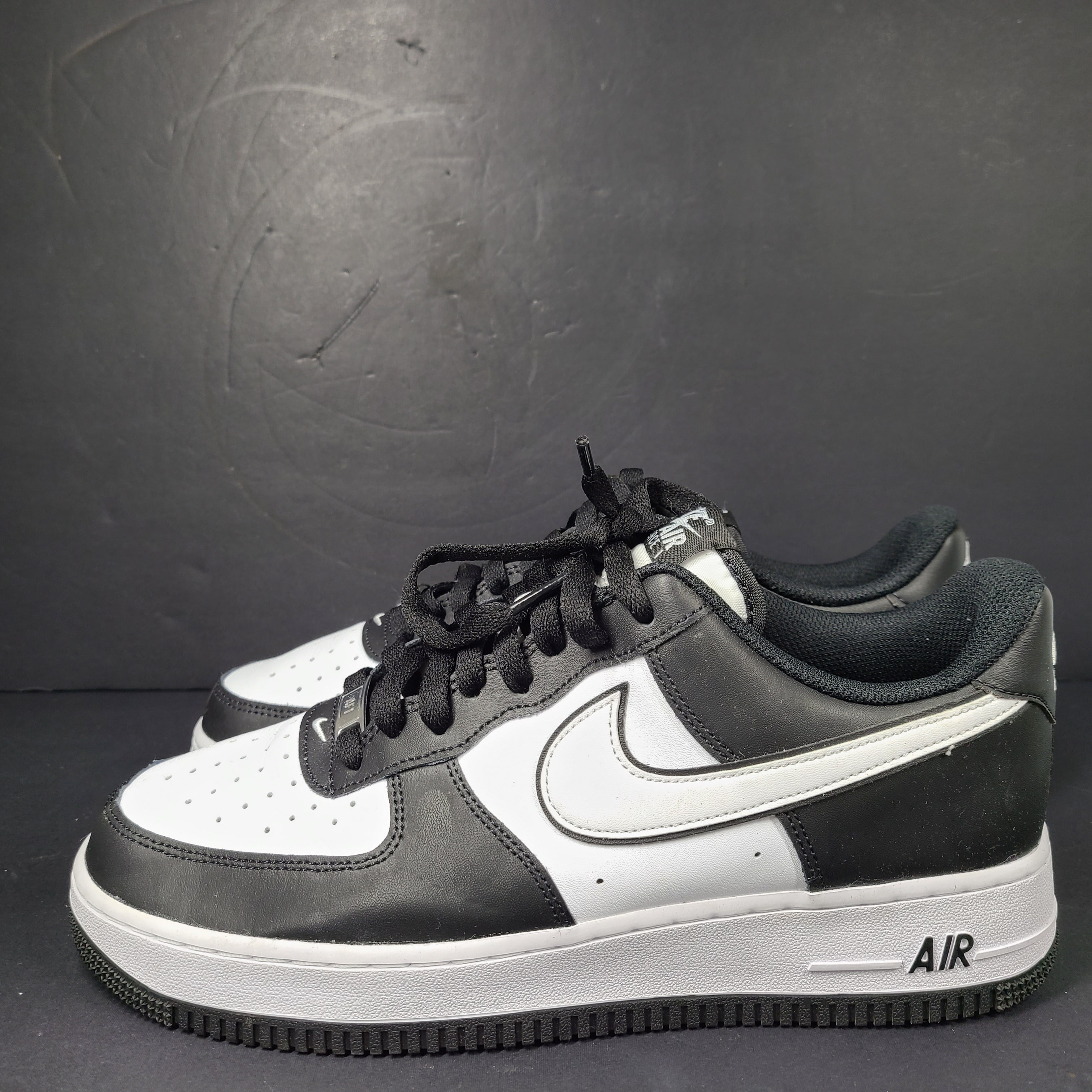 A stylish pair of Nike Air Force 1 Low sneakers in black and white.