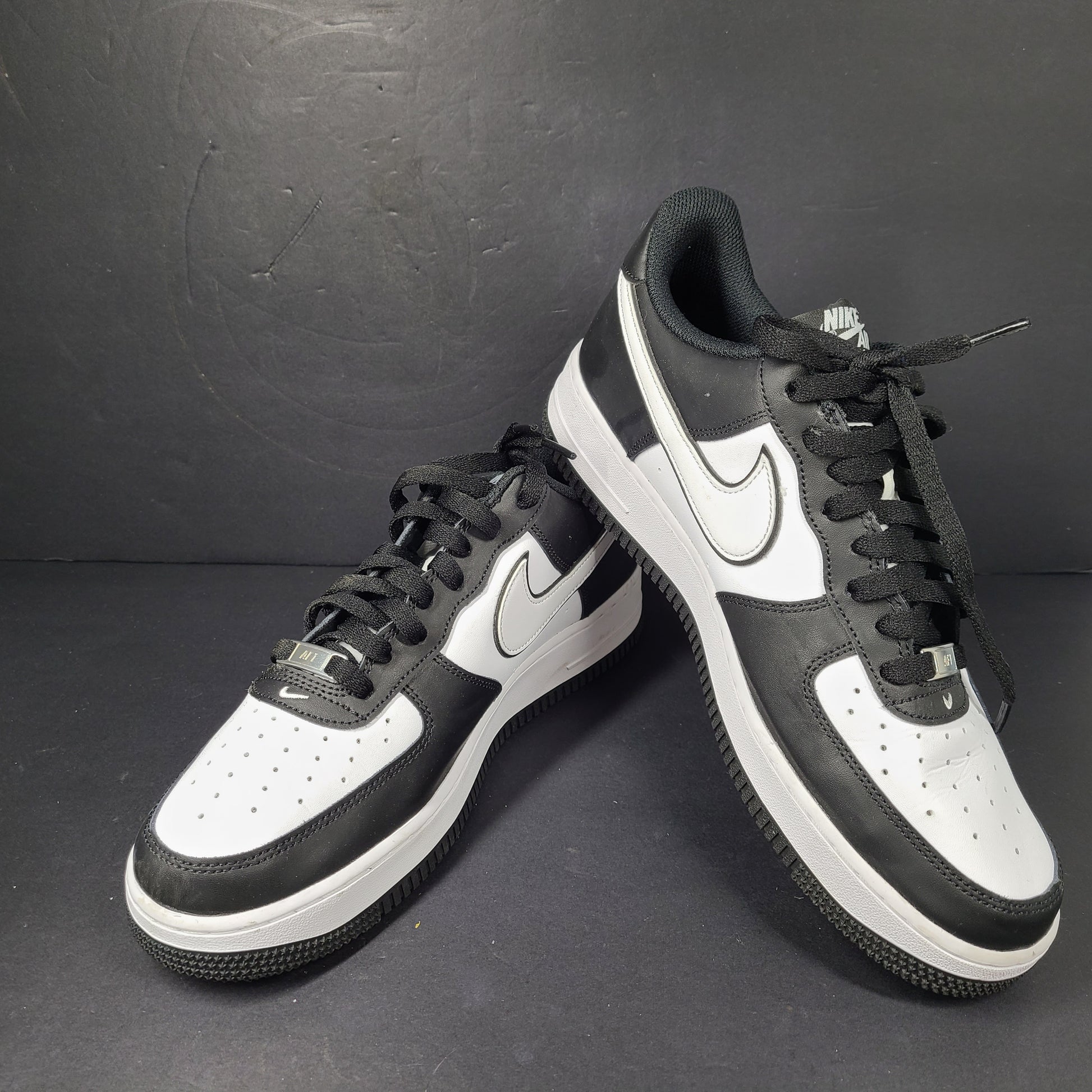 A stylish pair of Nike Air Force 1 Low sneakers in black and white.