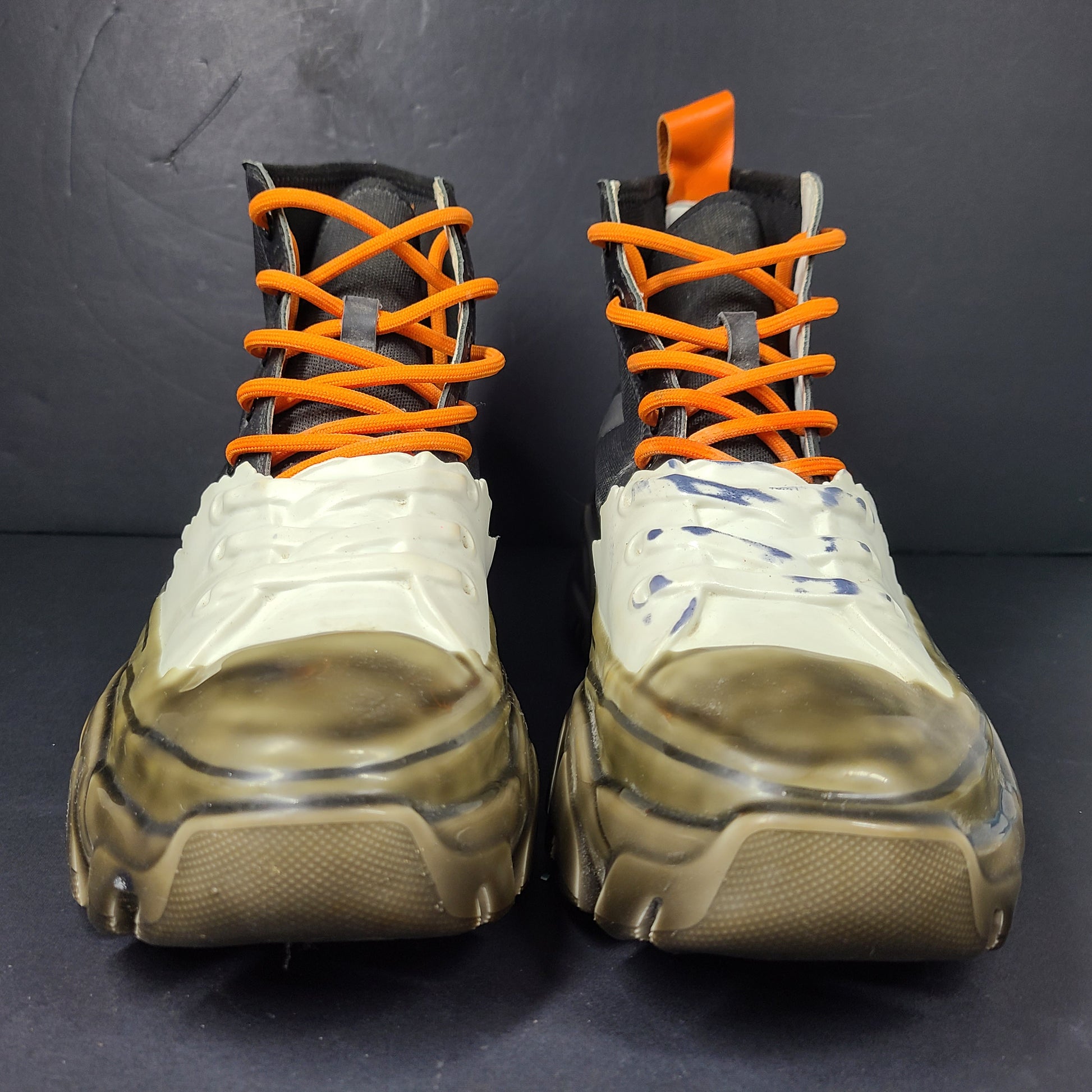 A pair of black and orange high top sneakers with Sz 41 for men.
