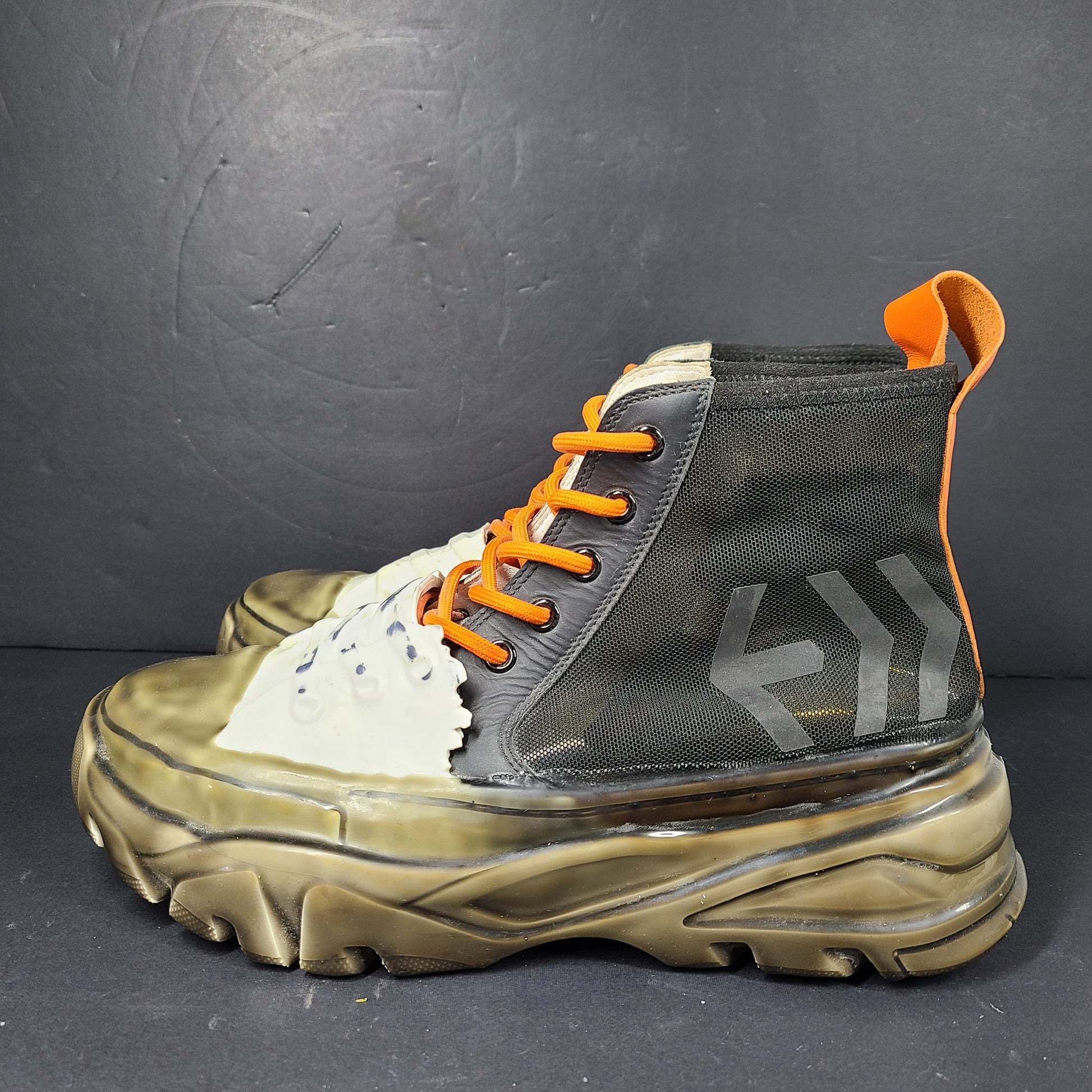 A pair of black and orange high top sneakers with Sz 41 for men.