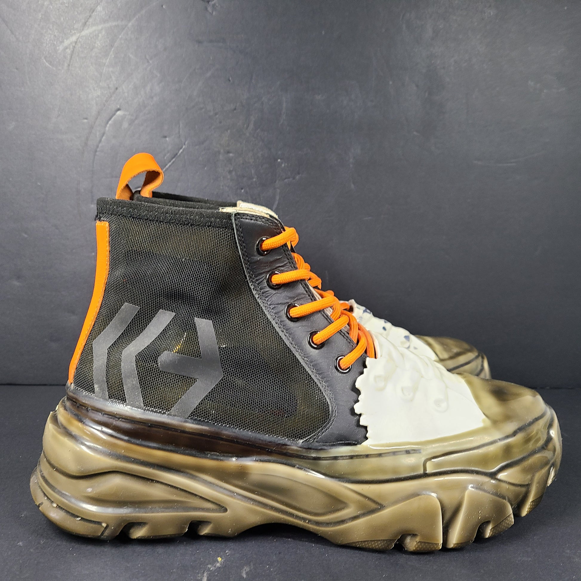 A pair of black and orange high top sneakers with Sz 41 for men.