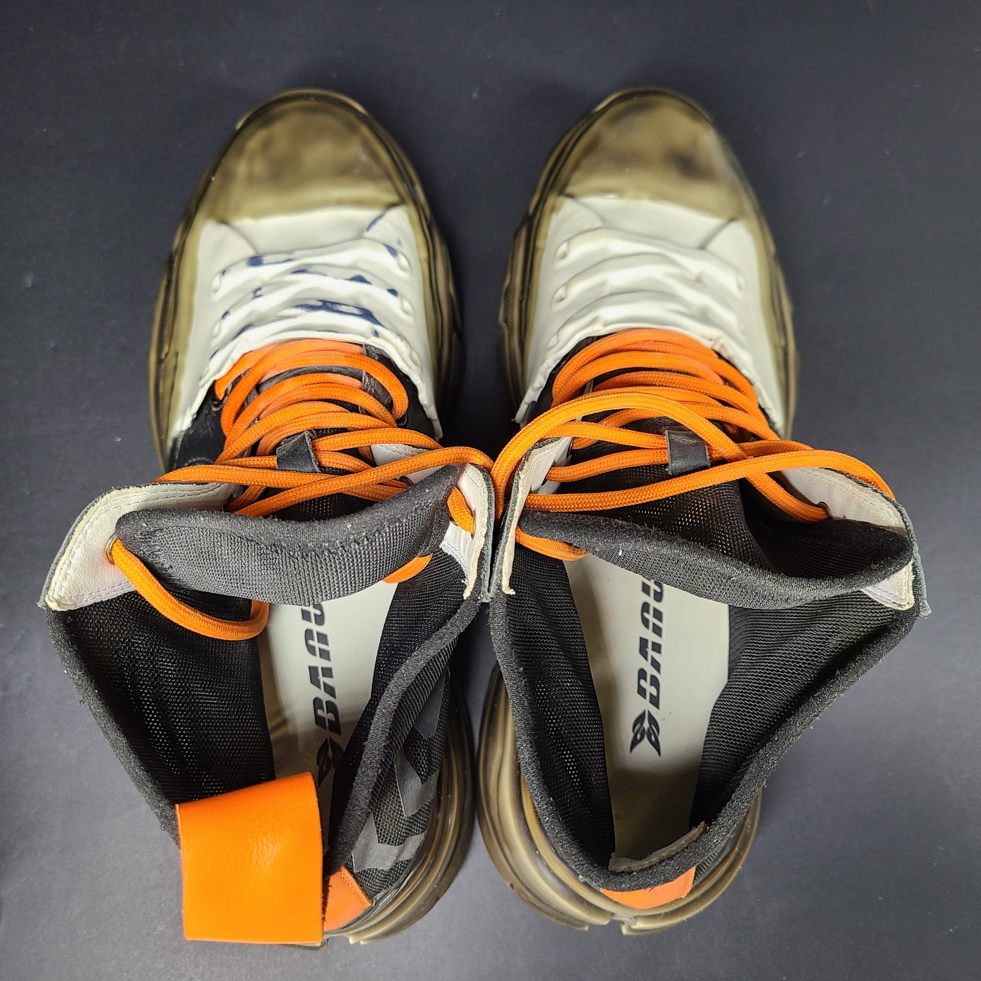 A pair of black and orange high top sneakers with Sz 41 for men.